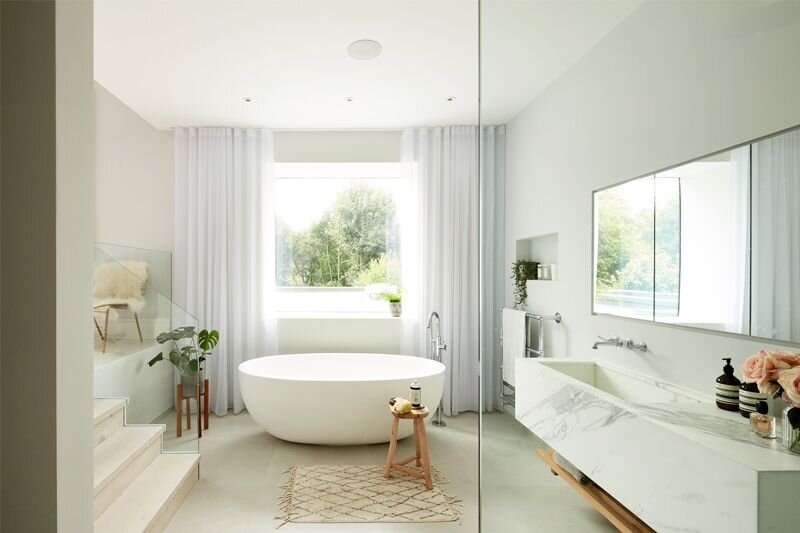 Large-bathroom-with-modern-freestanding-tub-and-marble-sink-window-curtains.jpg