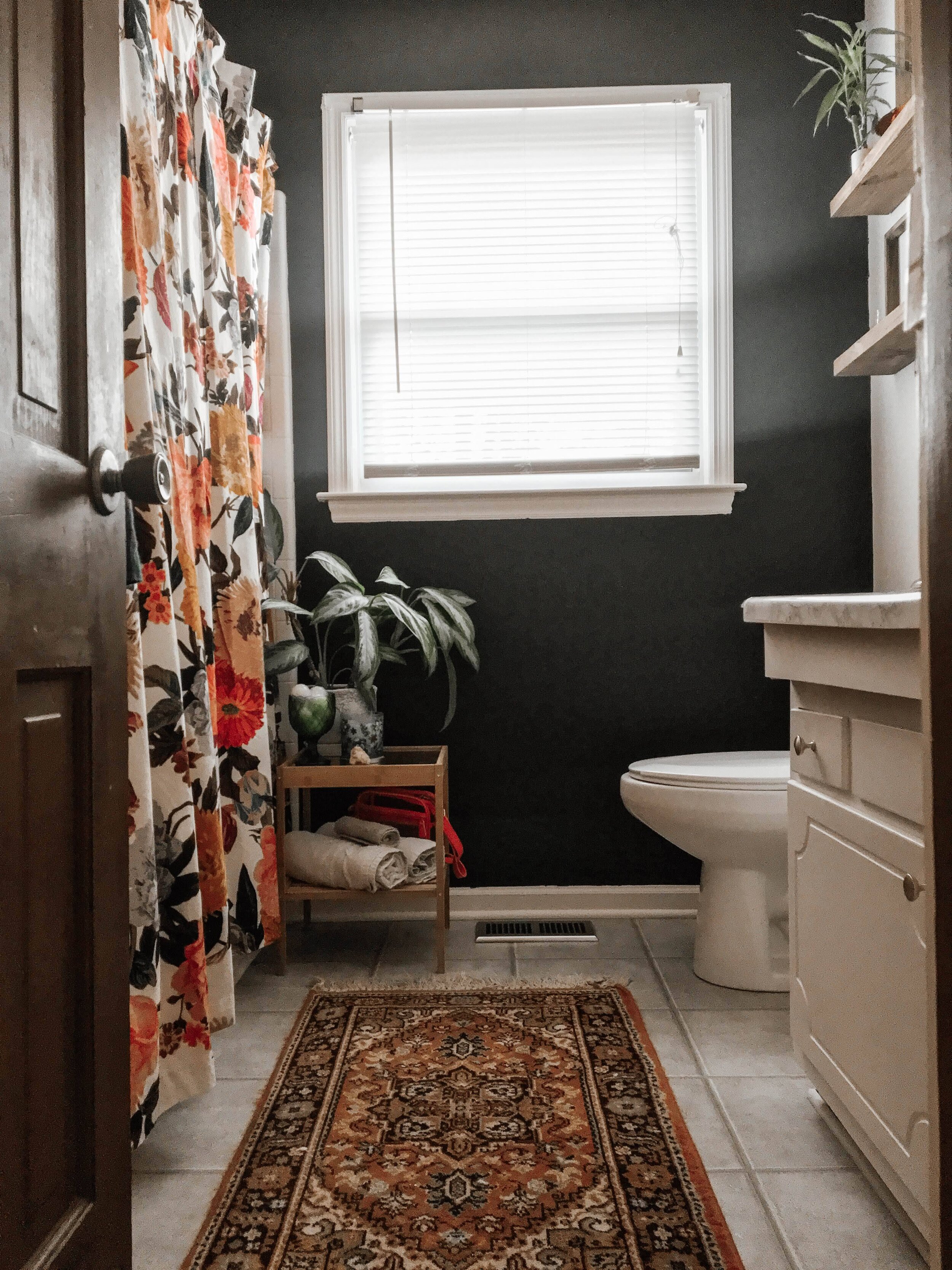 If you just want to hide an old tub area, go bold with big flowers on a new shower curtain