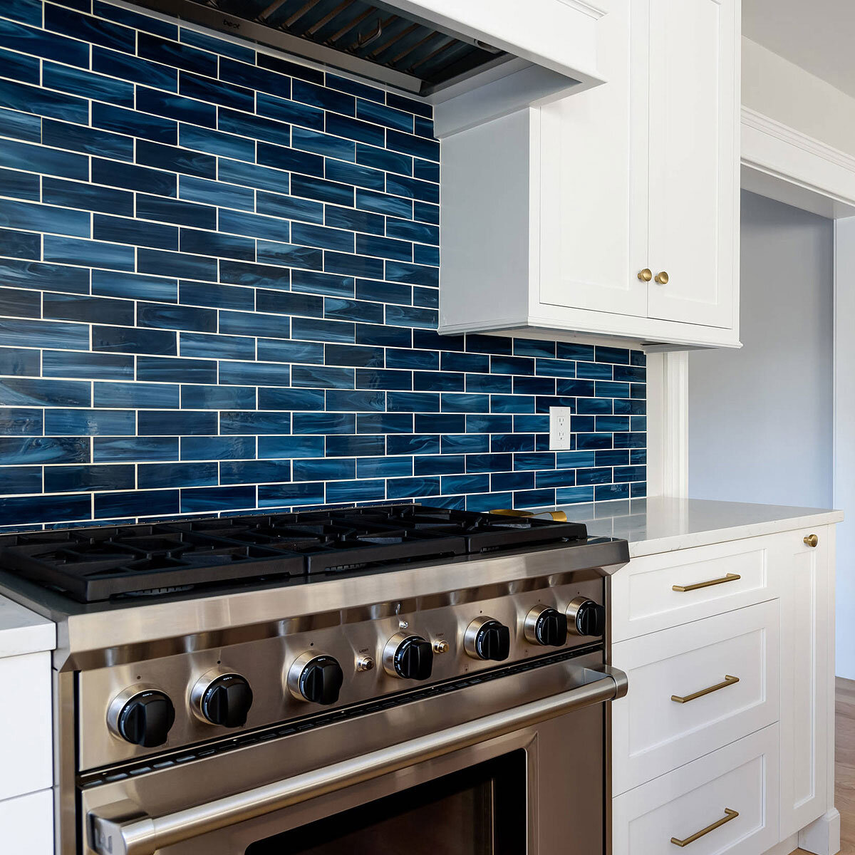 blue-subway-stained-kitchen-backsplash-tile-white-kitchen-cabinet-quartz-countertop.jpg