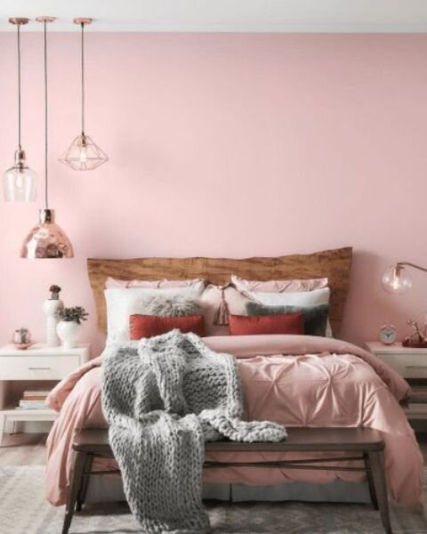 a-chic-contemporary-bedroom-with-a-pink-statement-wall-pink-bedding-grey-touches-pendant-lamps-and-white-furniture.jpg