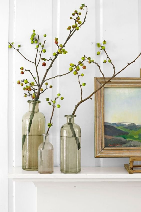a-trio-of-grey-clear-vases-with-branches-and-little-apples-on-them.jpg