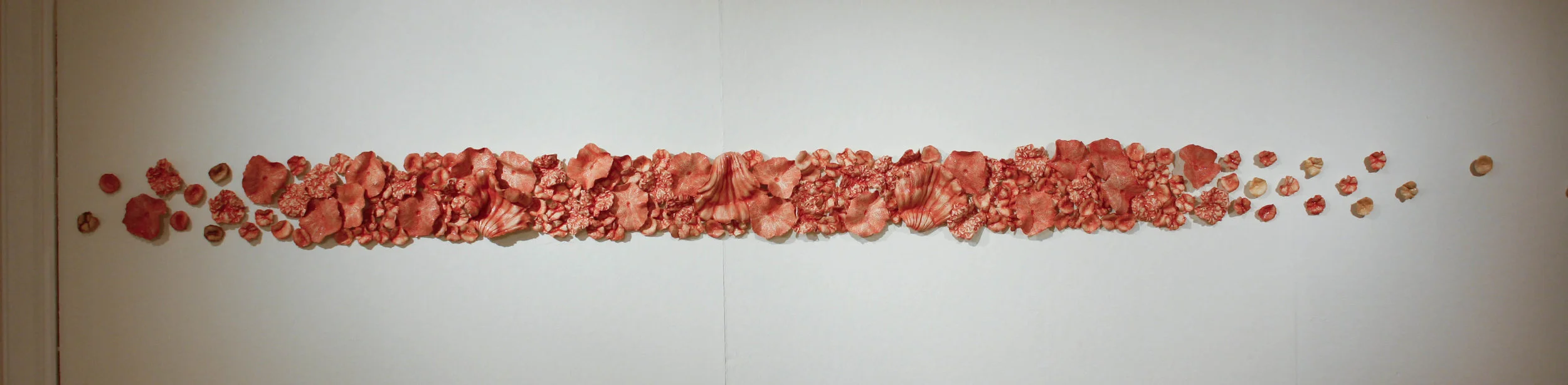 Jessica Kaminski, "Edgewater", press molded porcelain pieces with mason stains, 6ft long x 10" high, BFA exhibition, 2010