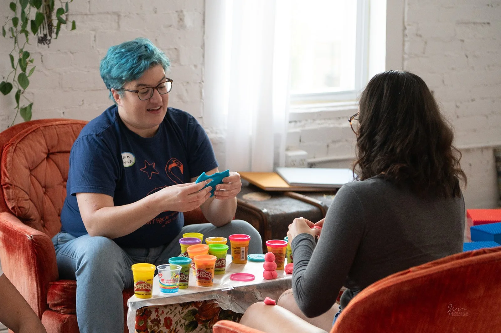 women talking over playdough
