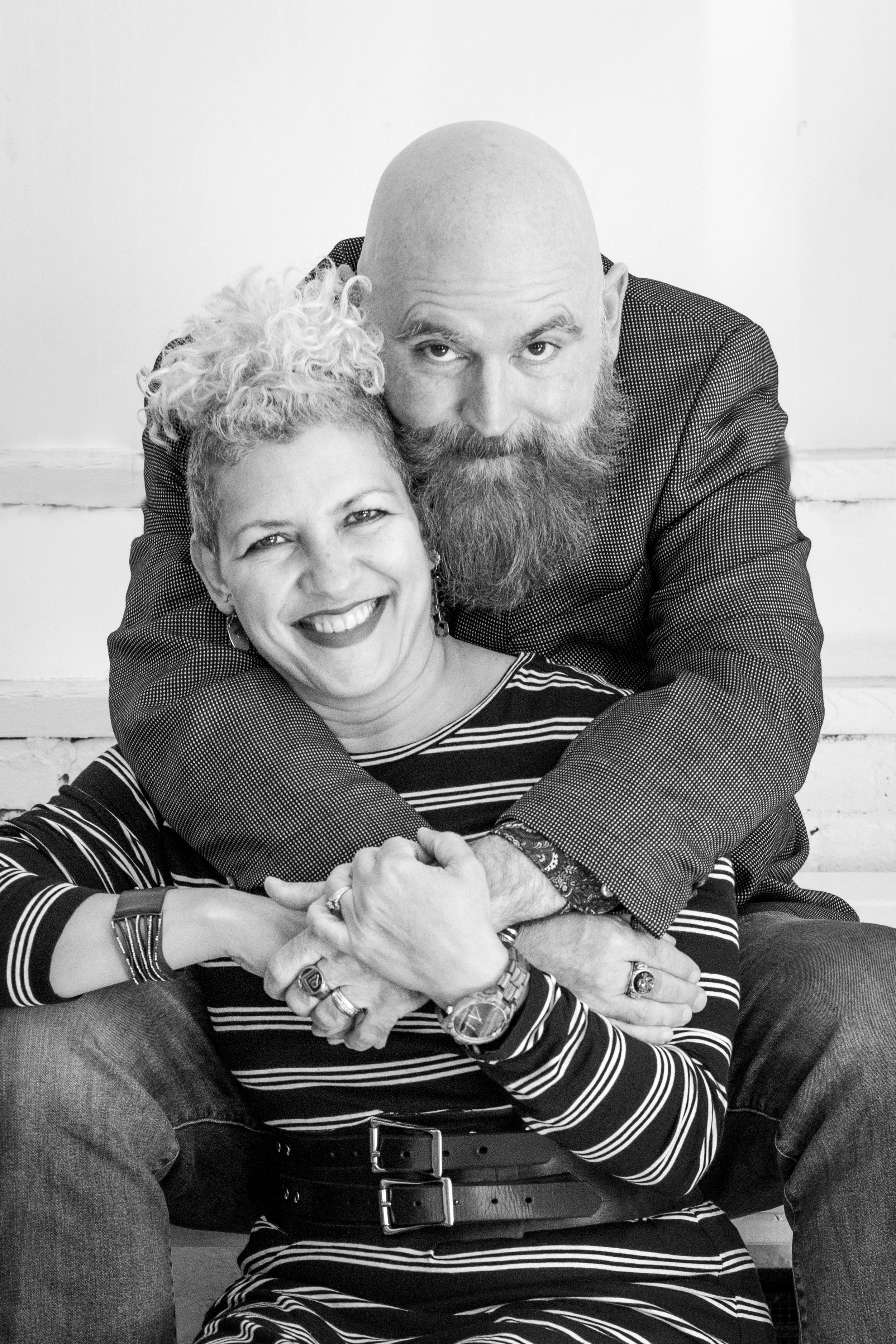 couple hugs and grins in black and white photo