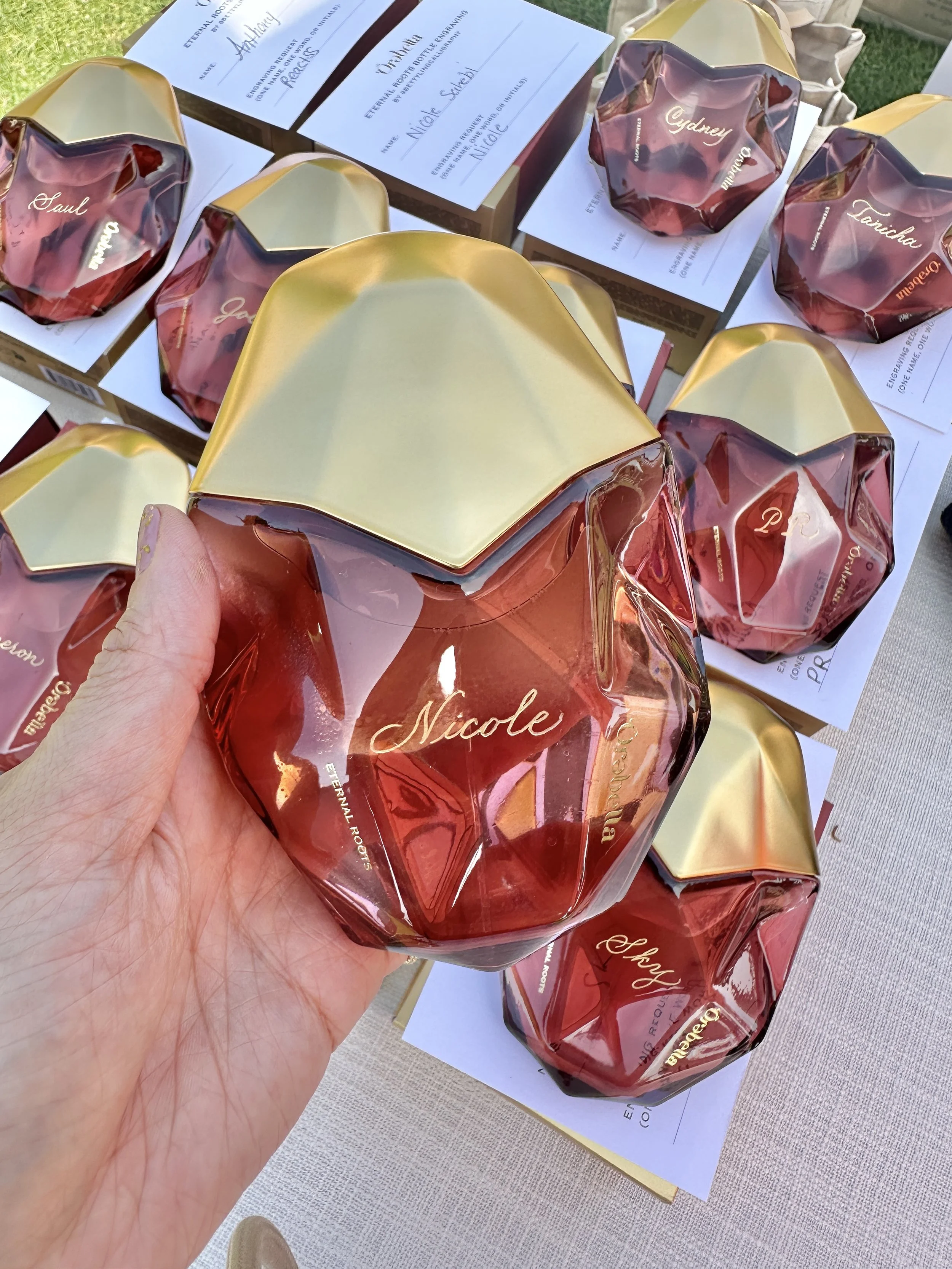  Betty Ling Calligraphy engraved perfume bottles for Orebella fragrances in Beverly Hills with guest names, filled with gold to match the brand’s logo. 