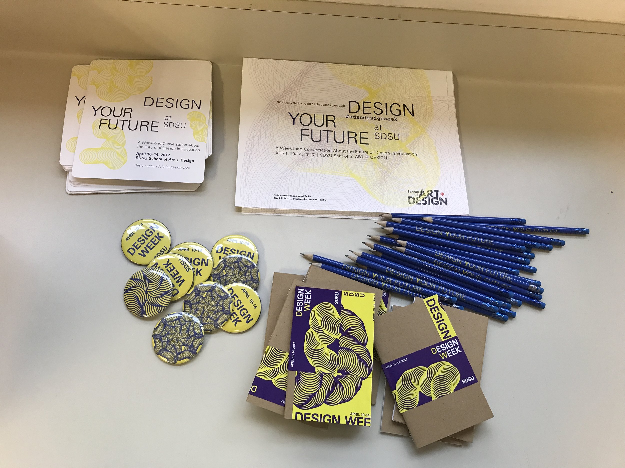  Collaborative design collateral consisting of stickers, pencils, notebooks, and a program. 