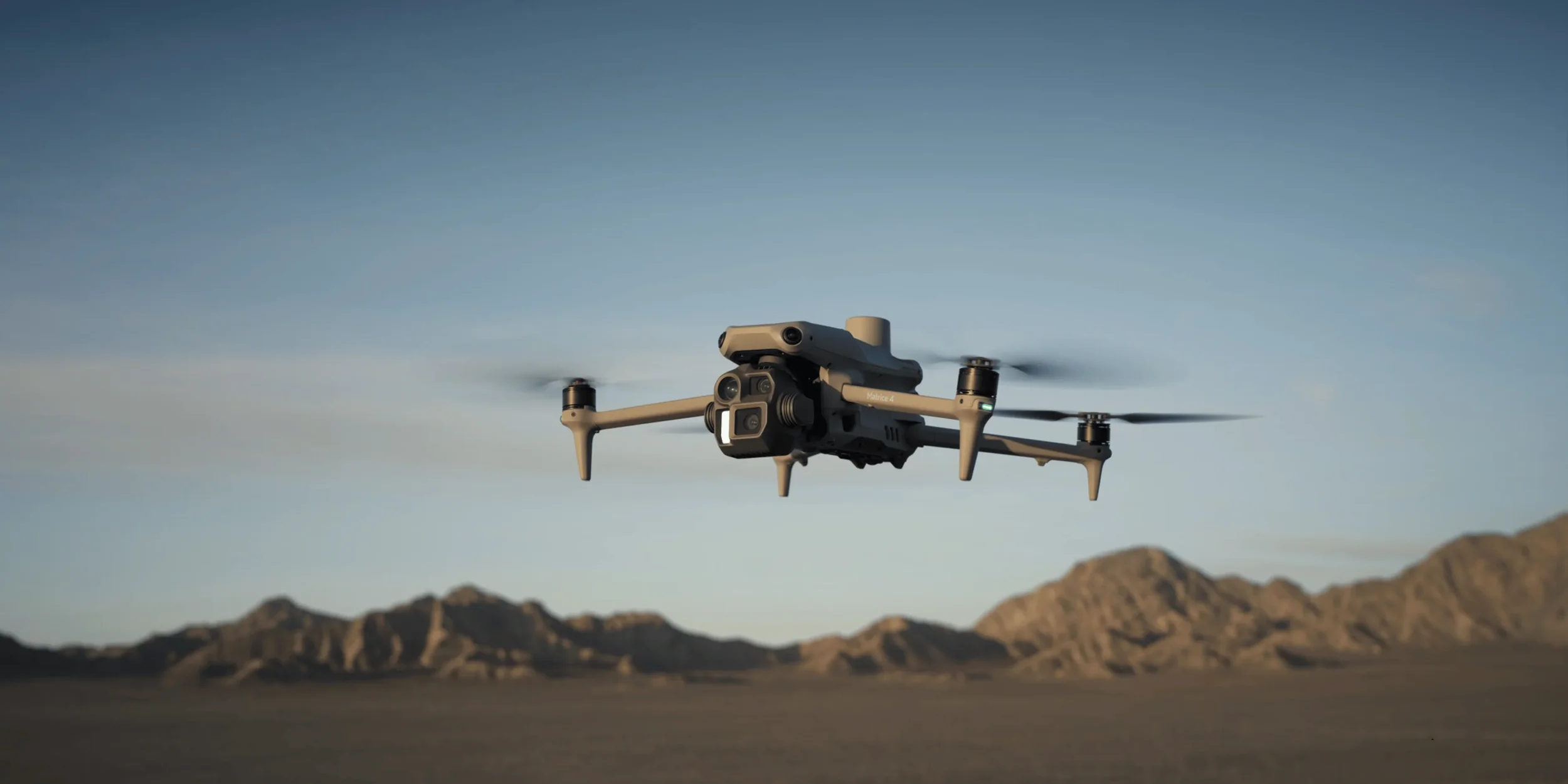 DJI Mavic 4 Enterprise drone flying over desert landscape