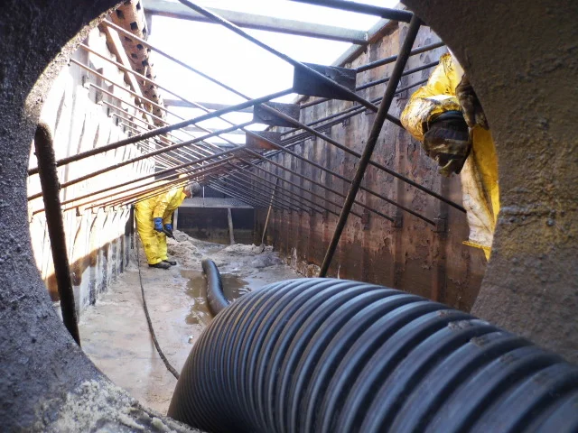 Our crew scrubs away some sludge during the water jetting portion of the process.