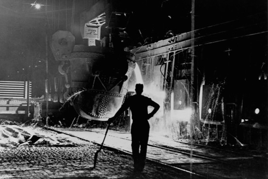 Hot metal from the Blast Furnace being poured into the steelmaking Open Hearth Furnace - 1950s