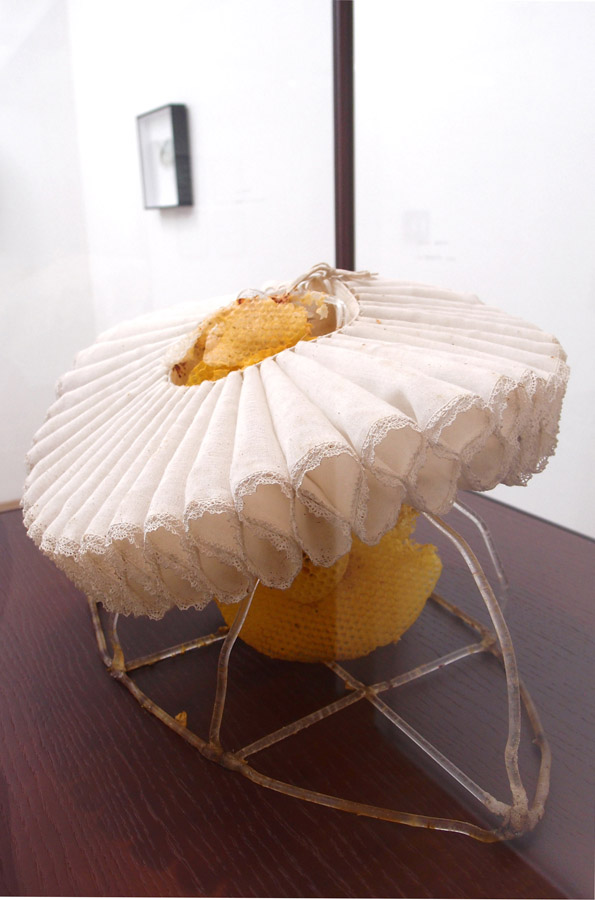 CELINE CLERON La Régente \ Regent, 2012. Tissu, cire d'abeille, tubes acryliques, bois, verre \ Fabric, beeswax, Plexiglass tubes, wood and glass. 35 x 54 x 45 cm.