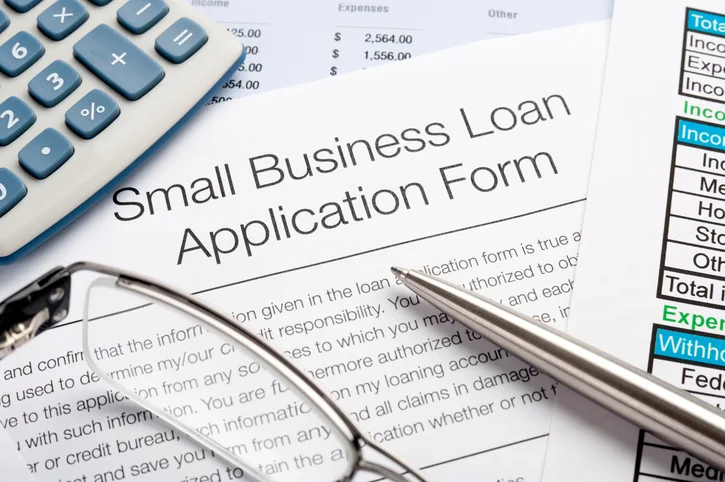 Small-business-loan-application-form-with-pen-calculator.jpg