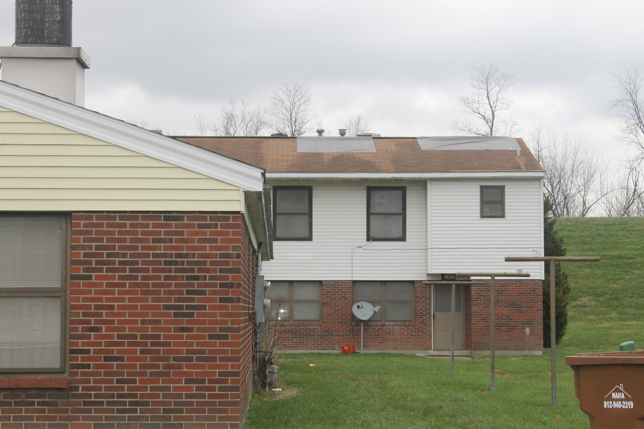 Tarps cover the roof at a public housing unit in New Albany.