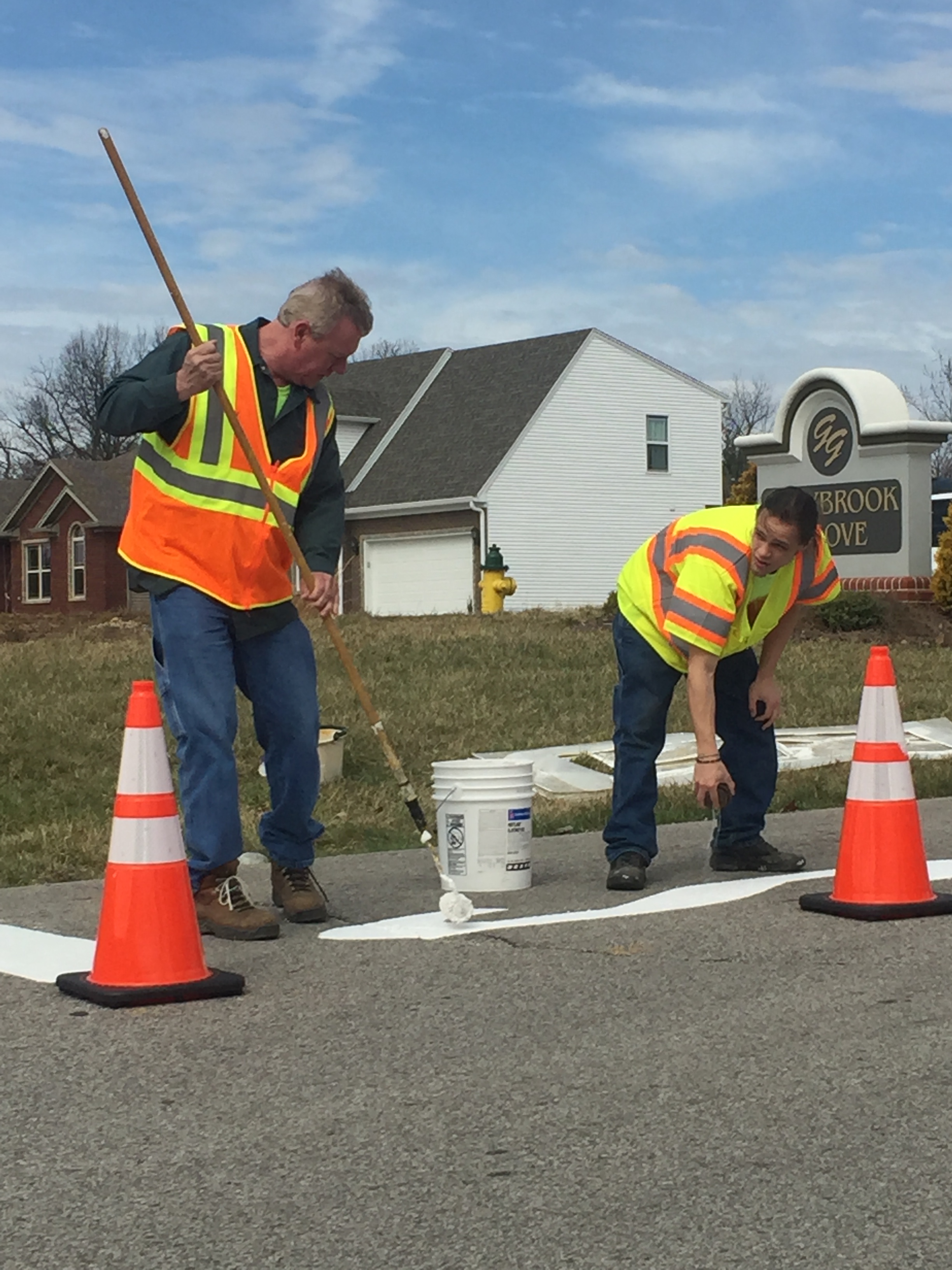 Crews work to repaint traffic signage.