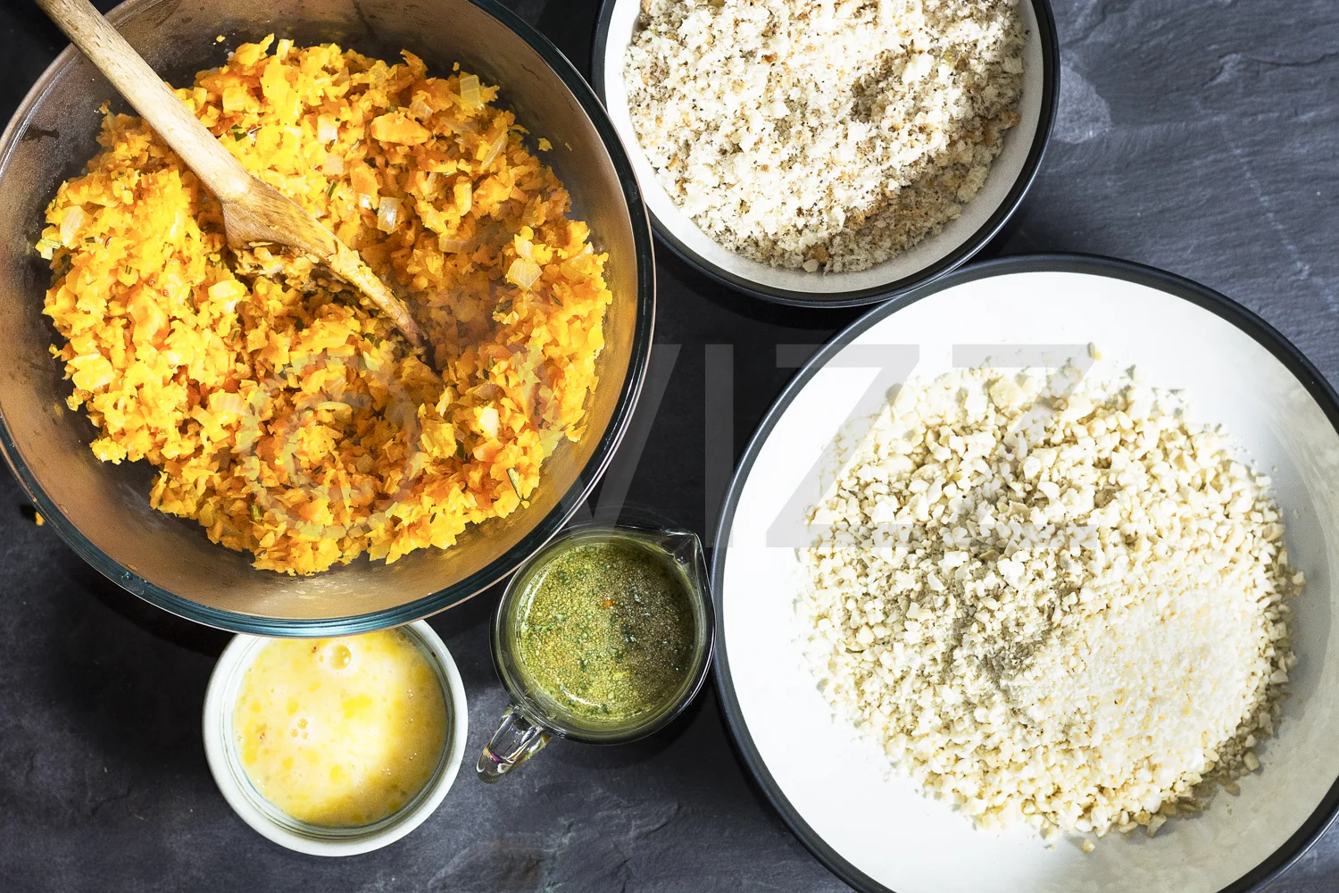 Add nuts, bread crumbs, and egg to the carrot. Then add the stock.