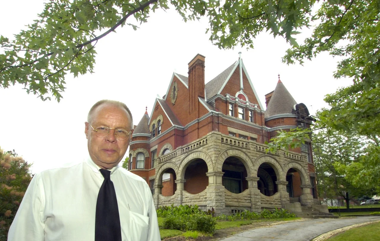 Mansion Savior Dr. Dixon poses for a picture in front of his house for an article in the Pittsburgh Post-Gazette. Image courtesy of Pittsburgh Post-Gazette