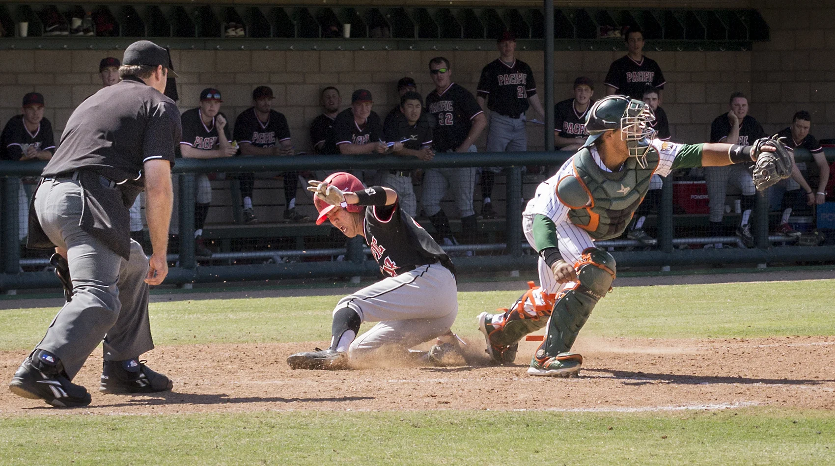 Pacific University freshman infielder/pitcher Cole Kanazawa scores in the top of the seventh inning during Sunday’s game at Ben Hines Field as University of La Verne catcher Nikko Williams catches the ball too late. The Leopards did not score in the seventh inning. The Pacific University Boxers defeated the Leopards with a final score of 11-6. The next baseball game will be Friday, April 3, at Occidental College.