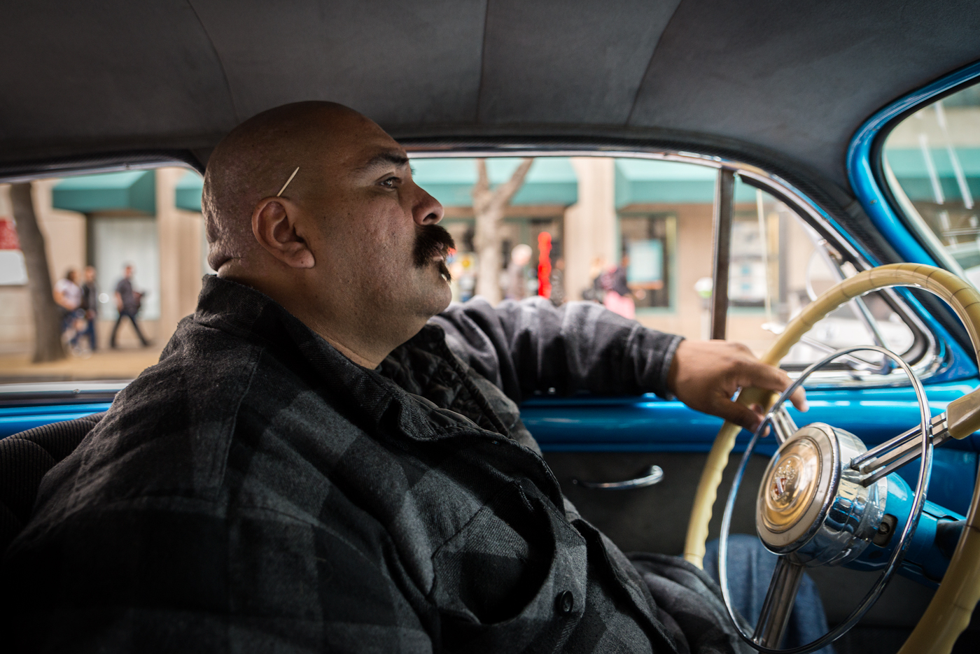 Carlos Rodriguez cruises his 1947 Buick Super - one of three lowriders his family owns. Rodriguez has been lowriding for the last 12 years. Though he did not grow up lowriding, he is determined to make the activity an integral part of his children's lives. ARASE / PHOTOGRAPHING 'SLOW AND LOW'
