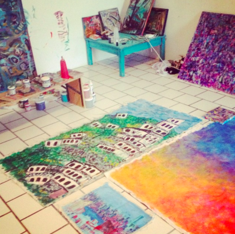 Working in Cori's studio. The brightly colored painting on the bottom right, is how this giant painting began...