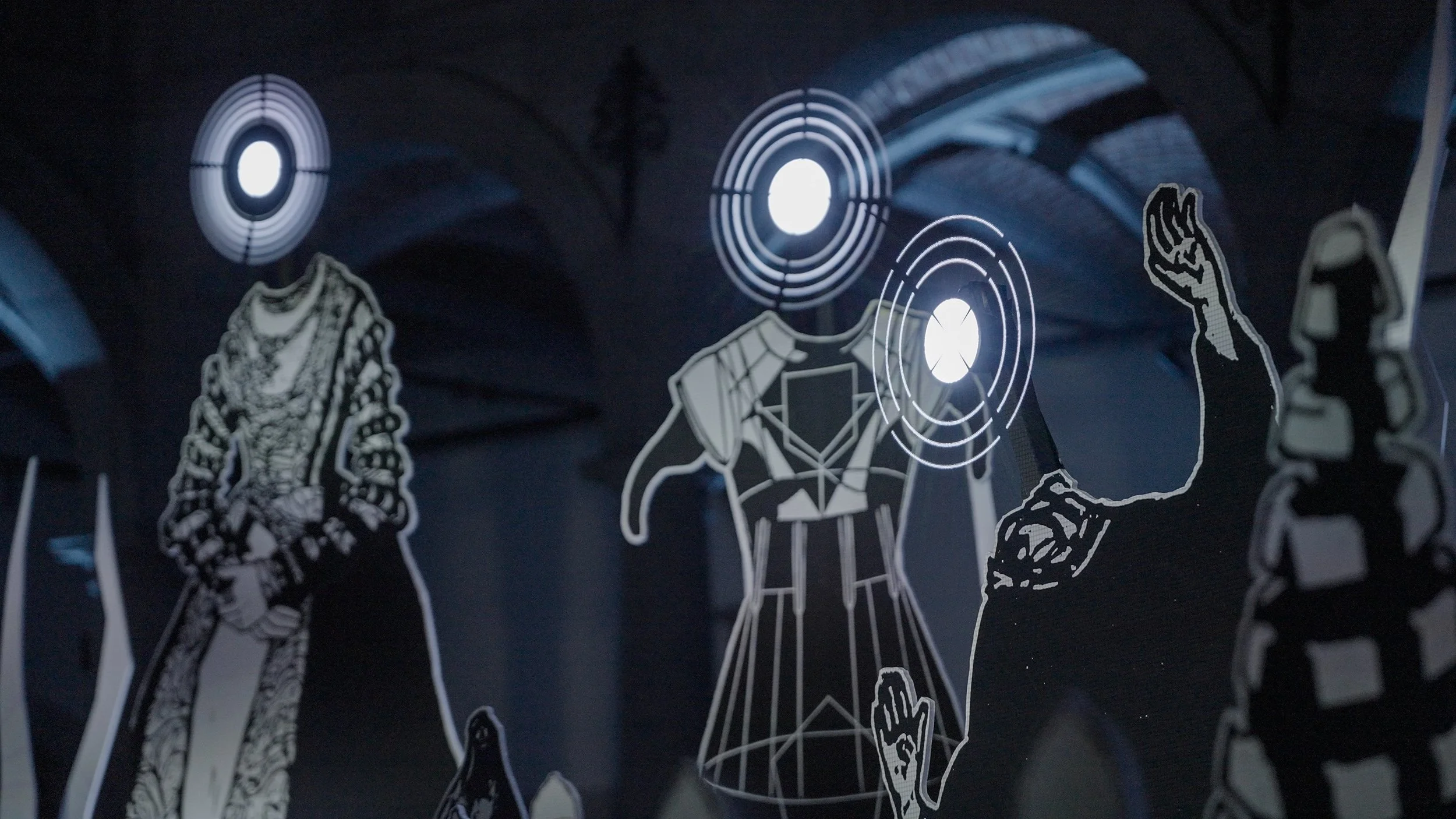 close-up on hybrid visual composition mixing engraved figures and light projections in a scenographic installation