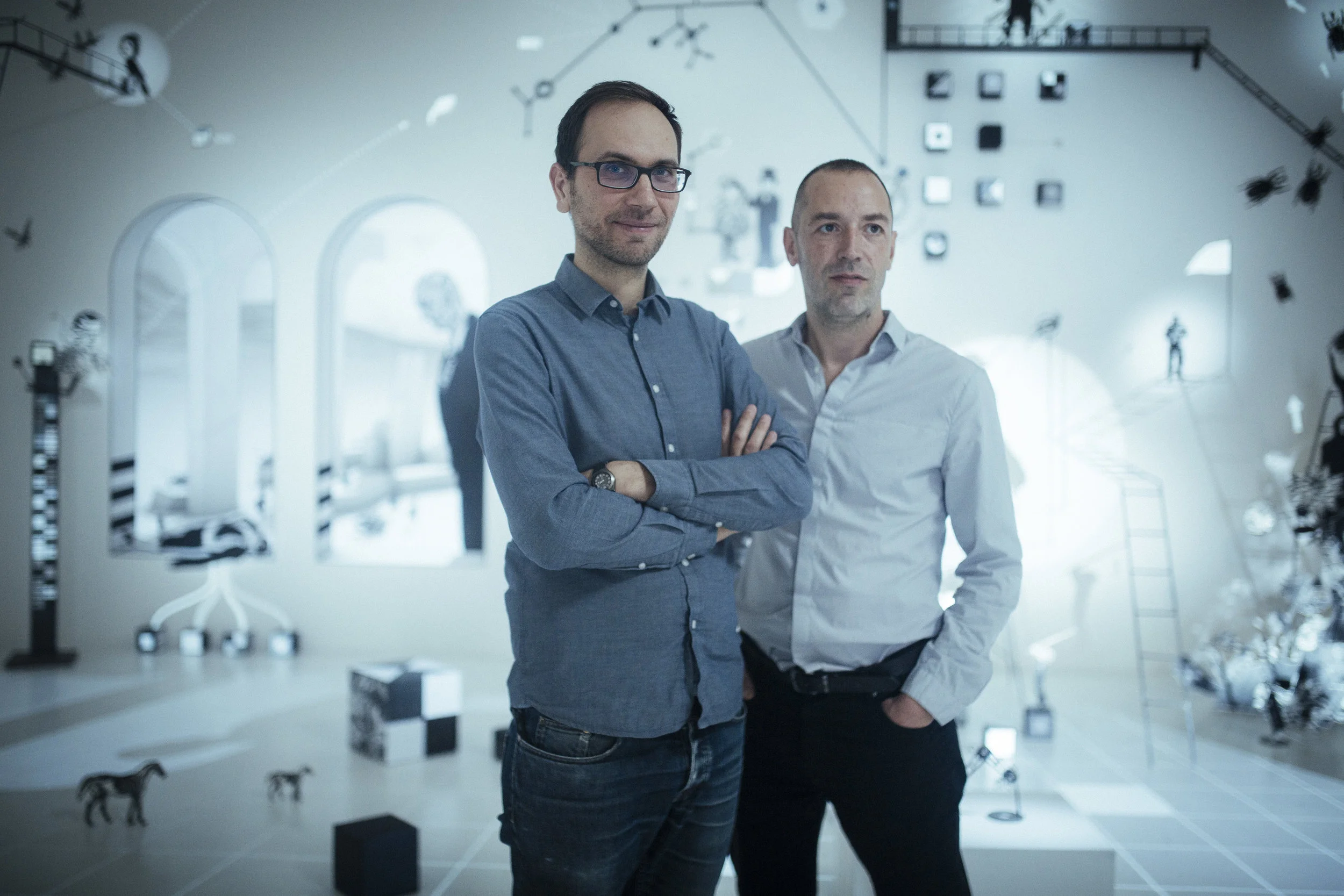 Portrait of artists Fred Penelle and Yannick Jacquet, creators of Mécaniques Discursives art projects combining woodcut and digital installation
