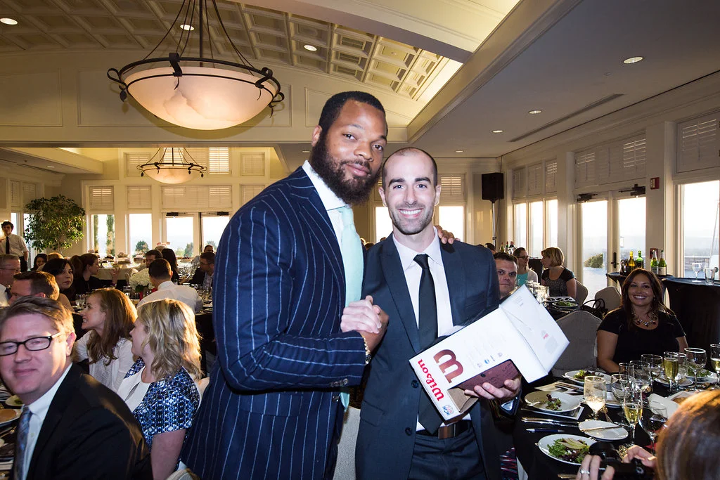  MIchael Bennett with the winning bidder, Cory Flynn 