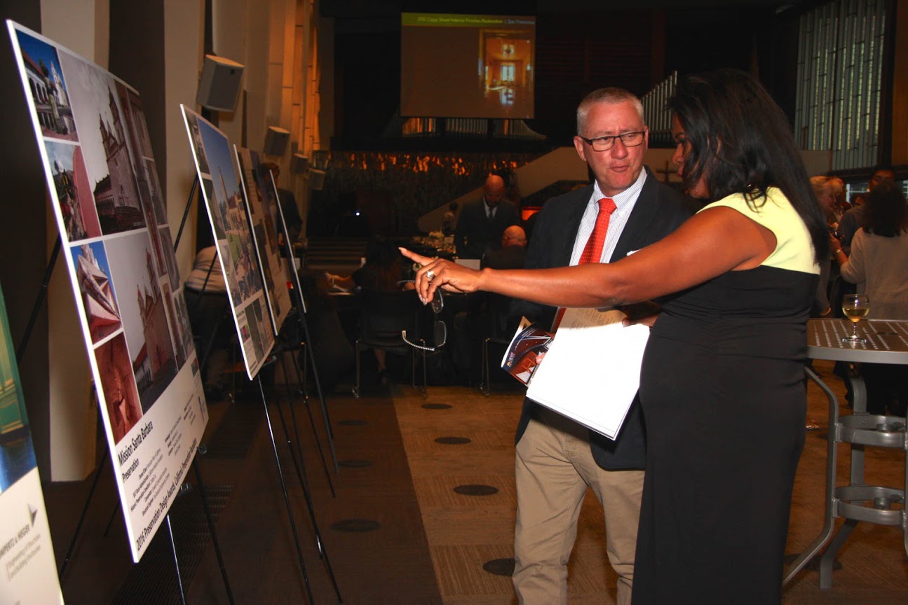 Awards attendees admire and discuss the Mission Santa Barbara project poster during the cocktail hour.