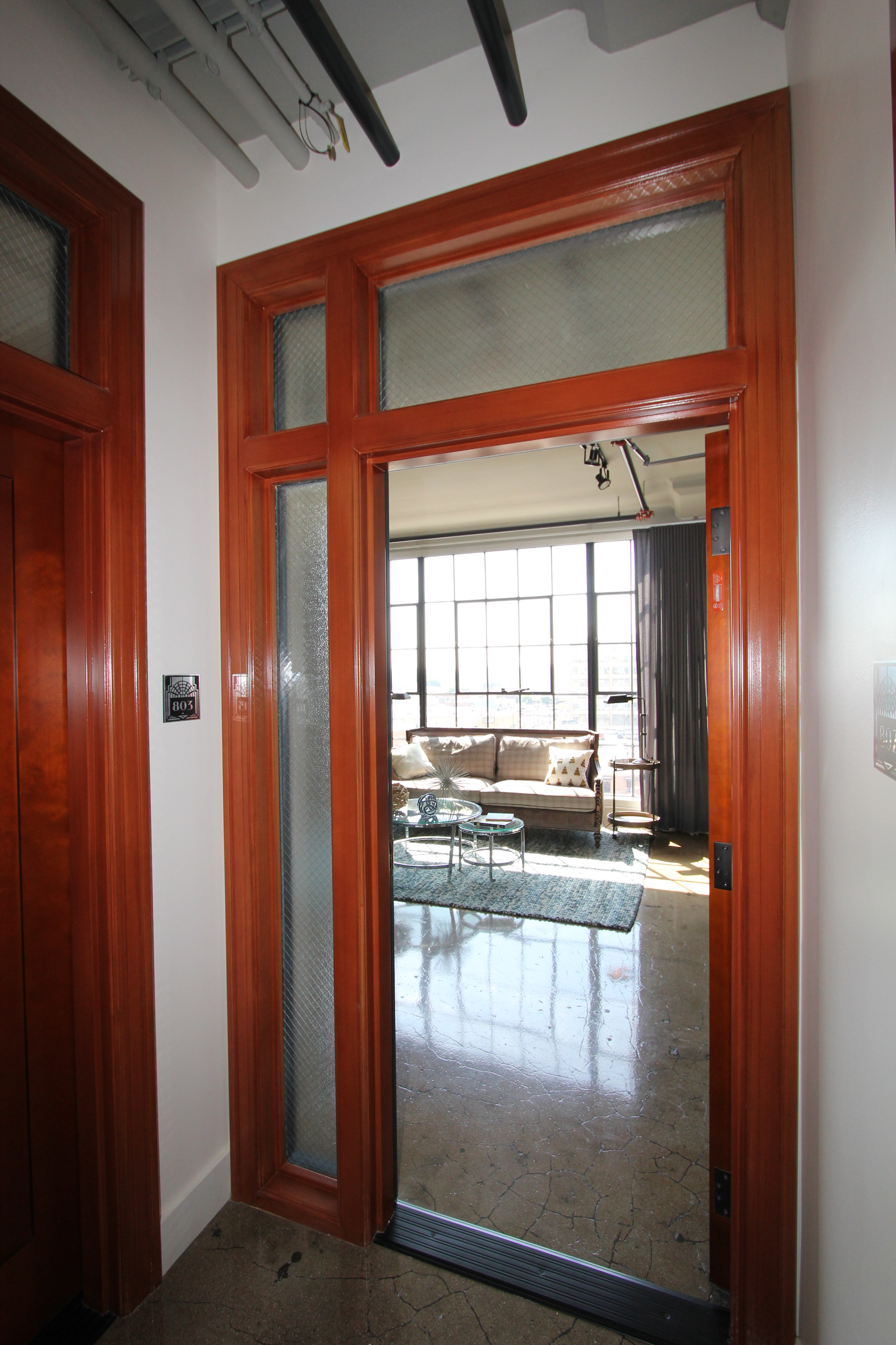 Interior wood door to unit, after rehabilitation.