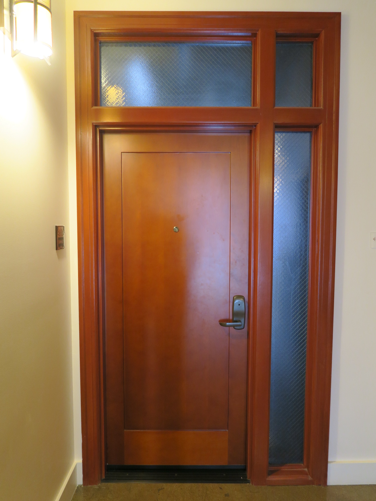 Interior wood door at residential unit, after rehabilitation.