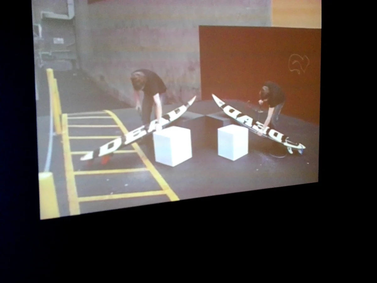 A video of 2 guys sawing through surf boards. I can't remember the artist