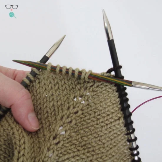 Here are the first 7 sts of the sleeve on the temporary needle.