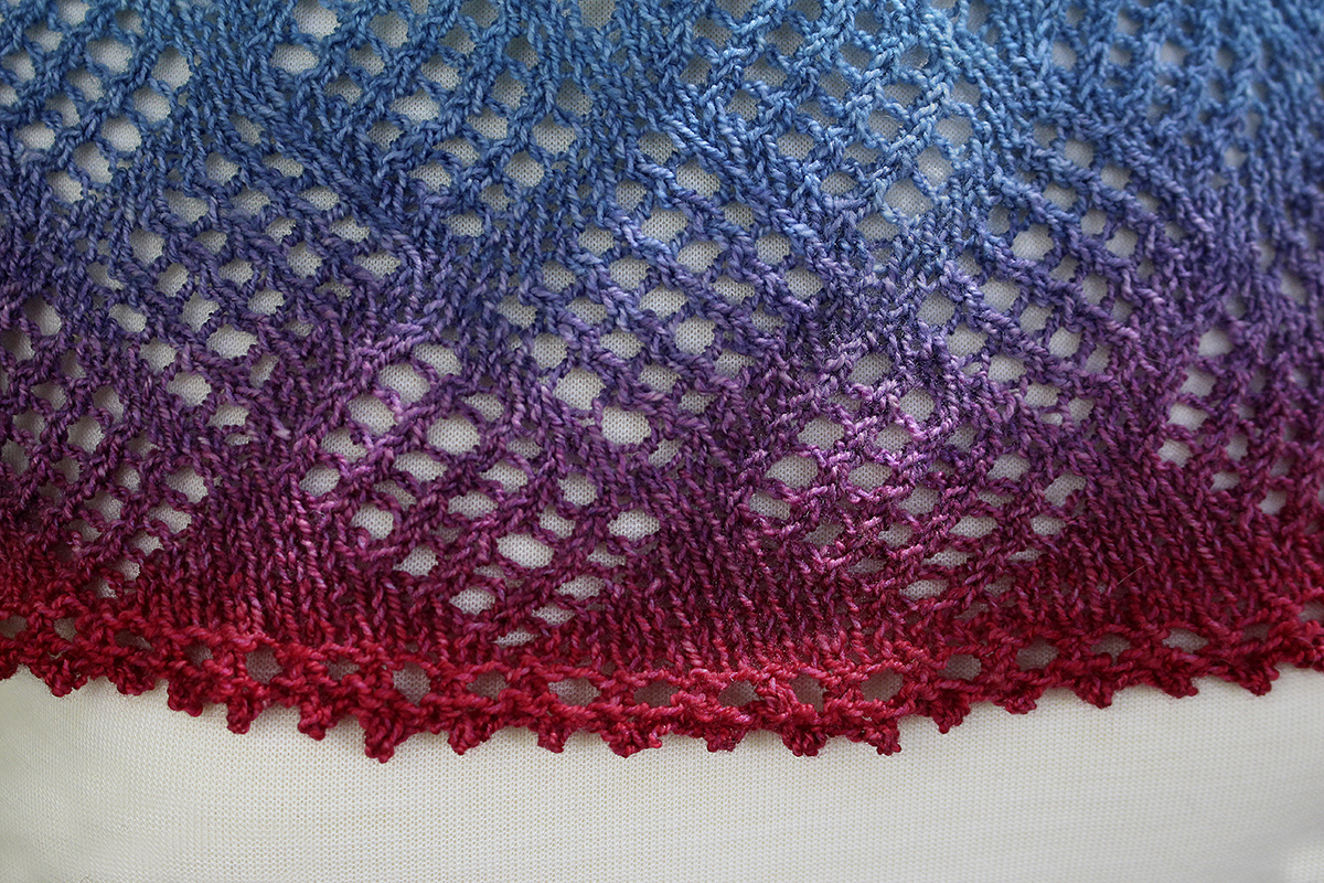 Thanos Theory - a fingering weight single-skein hand knit crescent shaped shawl with a simple lacework center panel and a picot bind off edge. 
