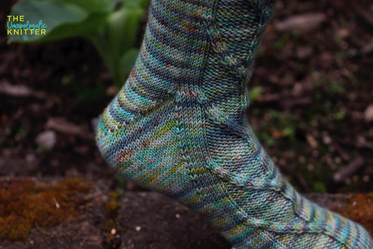 White Hart - Toe-up hand knit socks featuring a Fleegle heel and a traveling stitches pattern on the front of the sock