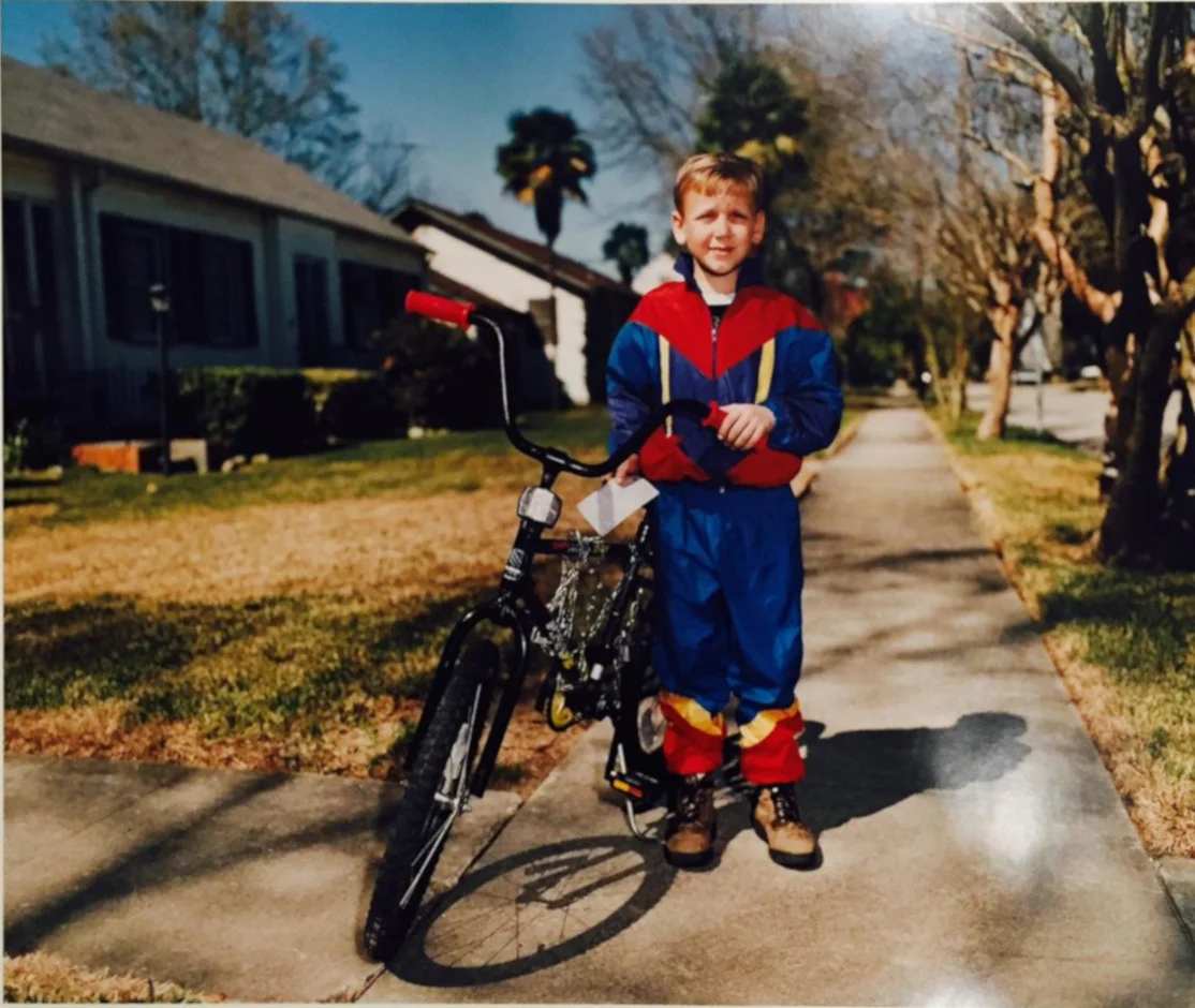 Boy Holding Check Near Bike, Metairie, LA