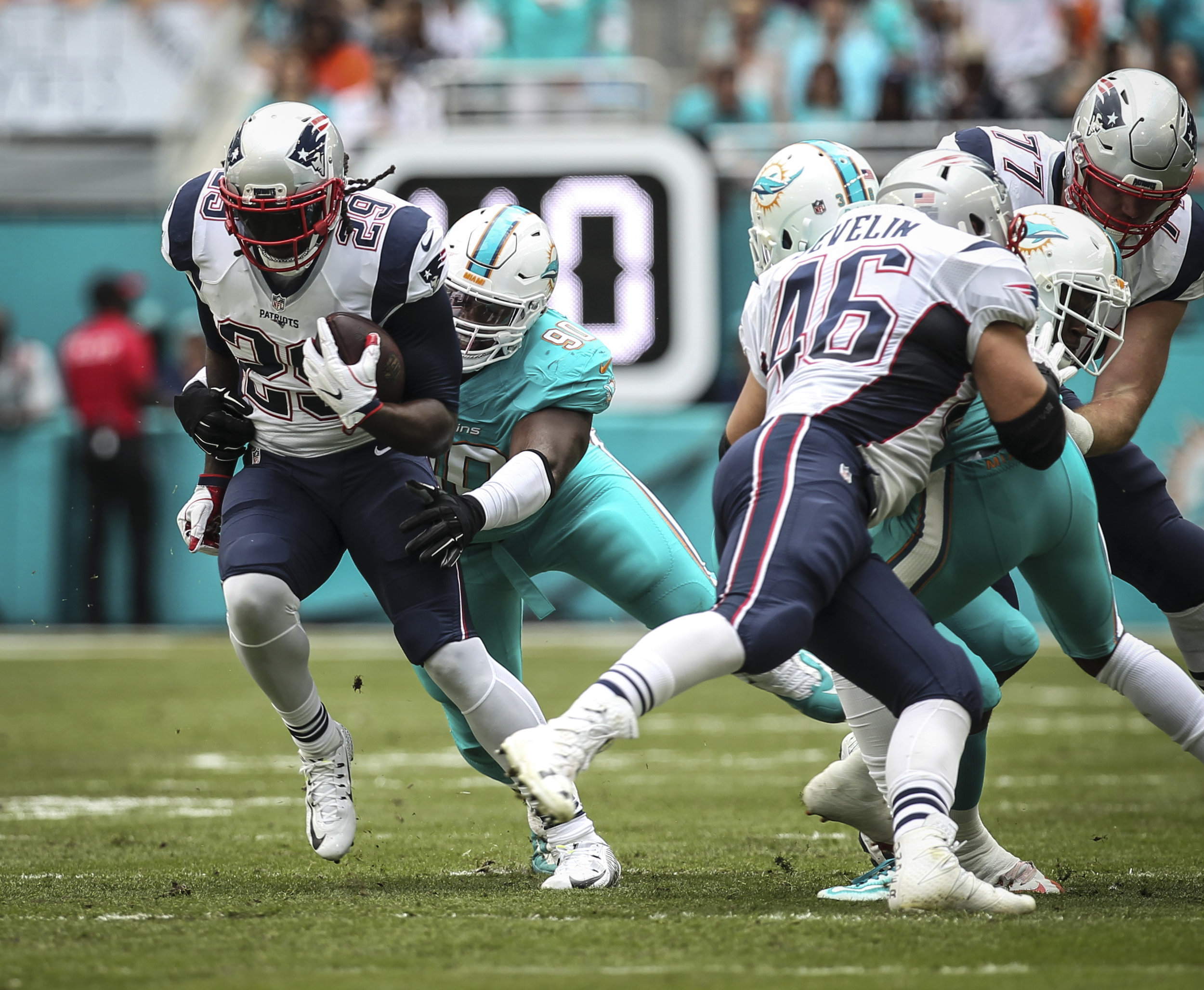 New England Patriots running back LeGarrette Blount (29) breaks loose of a tackle by Miami Dolphins defensive tackle Earl Mitchell (90). Blount rushed for 44 yards on 9 carries against the Dolphins at Hard Rock Stadium in Miami Gardens, Florida, Jan
