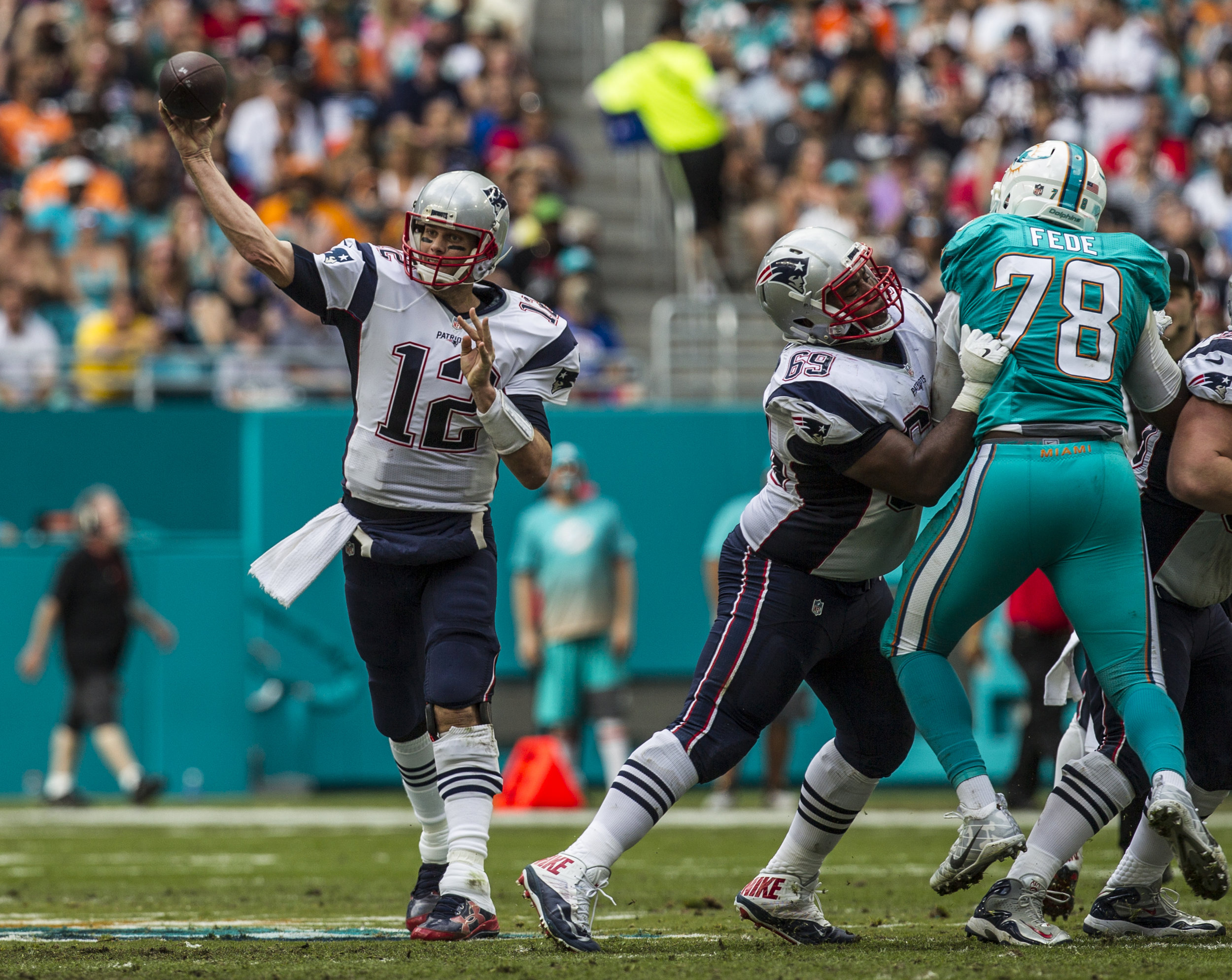  New England Patriots quarterback Tom Brady (12) attempts to complete a pass at Hard Rock Stadium in Miami Gardens, Florida, January 1, 2017. Brady finished with 273 yards and 3 touchdowns in the 35-14 win over the Dolphins. 