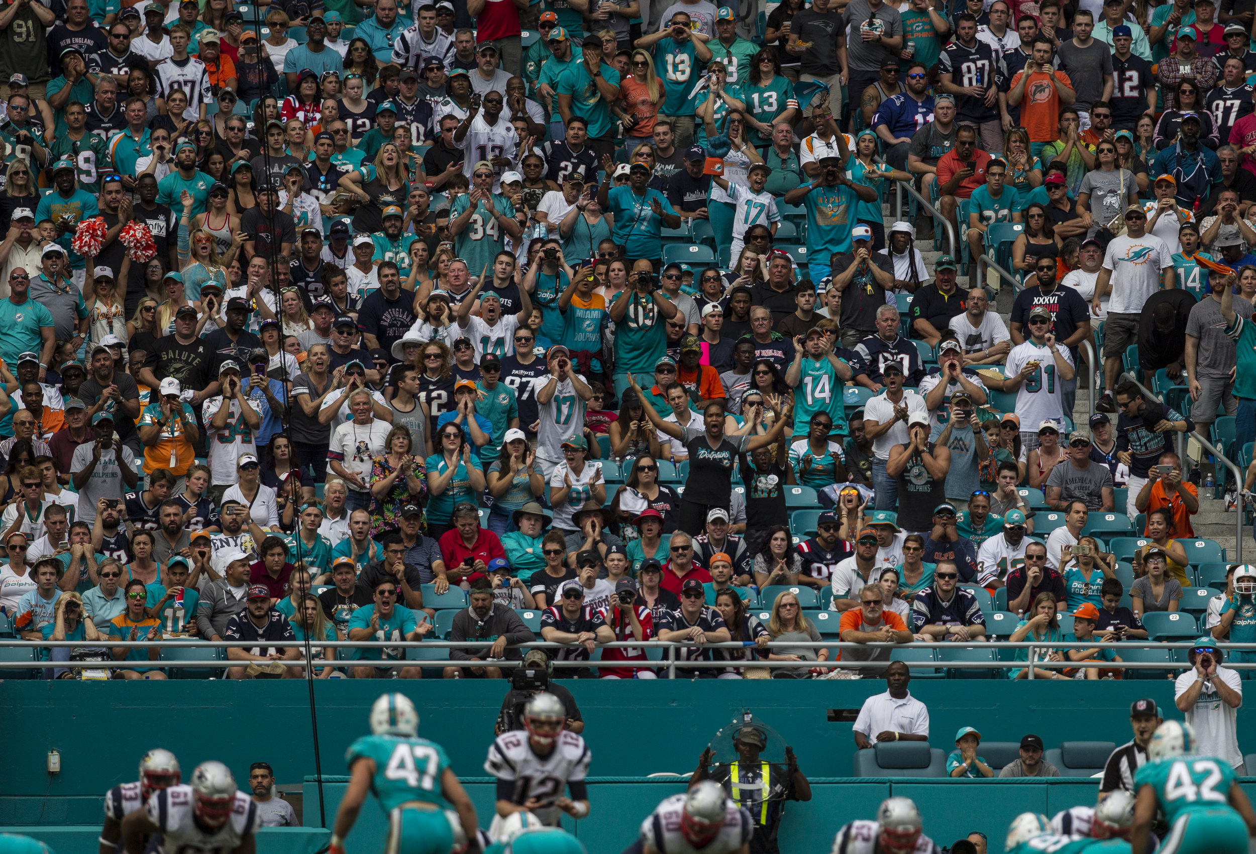  Miami Dolphins fans make some noise as New England Patriots quarterback Tom Brady (12) gets ready to snap the ball at Hard Rock Stadium in Miami Gardens, Florida, January 1, 2017. 