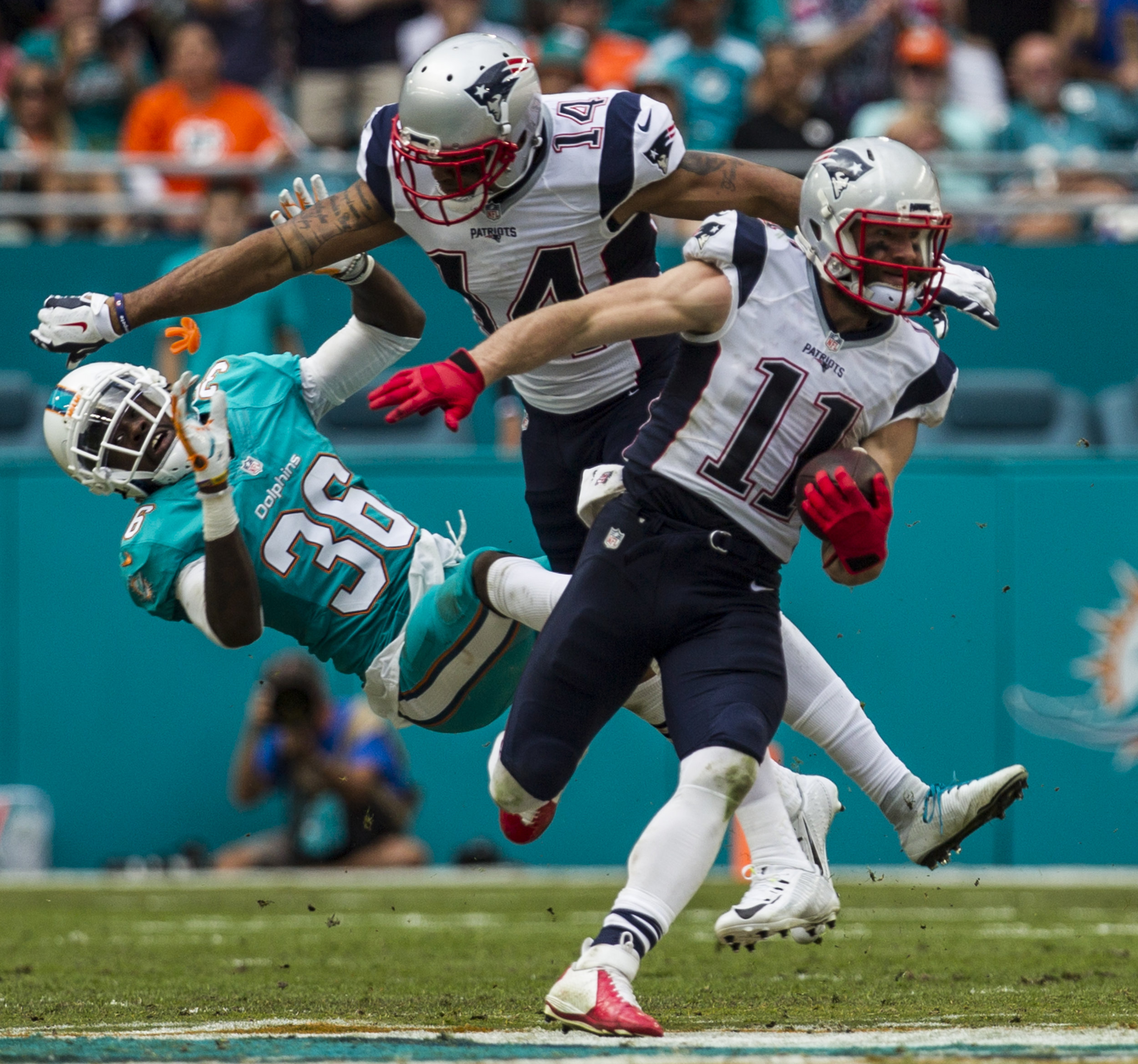  Miami Dolphins cornerback Tony Lippett (36) gets blocked by Patriots receiver Michael Floyd (14) as Julian Edelman (11) breaks free for a touchdown at Hard Rock Stadium in Miami Gardens, Florida, January 1, 2017. 