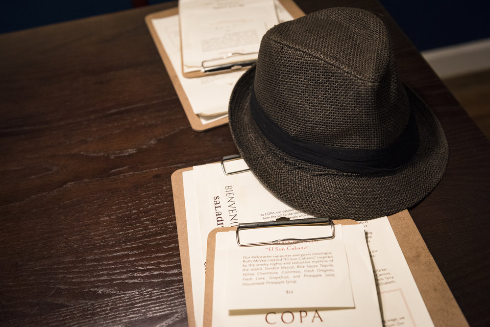  Roberto's hat sits on a table while he eats. "The law makes us wear something on our heads while we are in the kitchen and I thought I would wear something that fit the theme of the restaurant," said Matos about his choice of wearing the traditional
