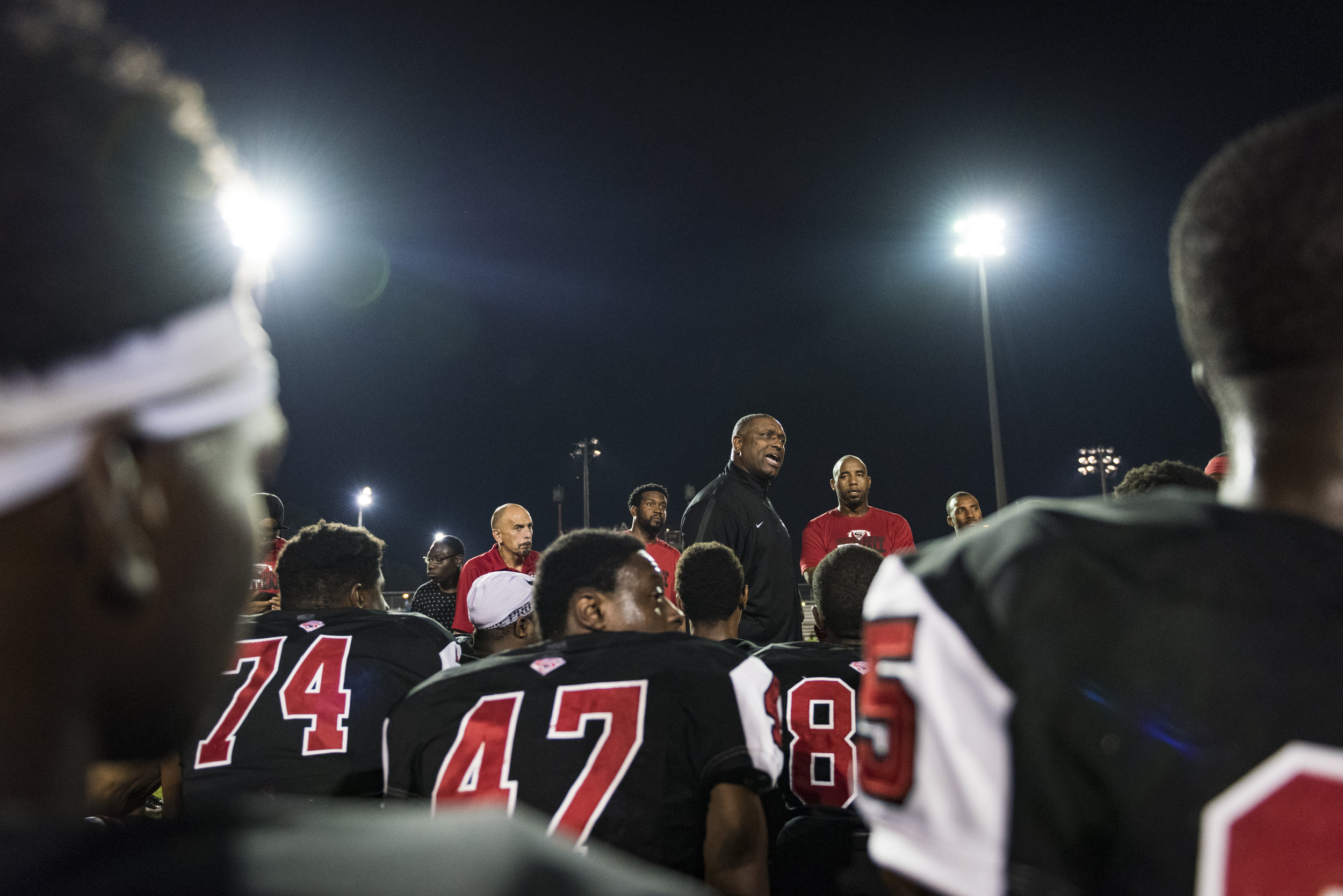  Southern Durham head coach Darius Robinson addresses his team after a big win against the the No. 4 team, Seventy-First High School. The Spartans scored nine points in the final 78 seconds of the game to finish the upset, 36-32. 
