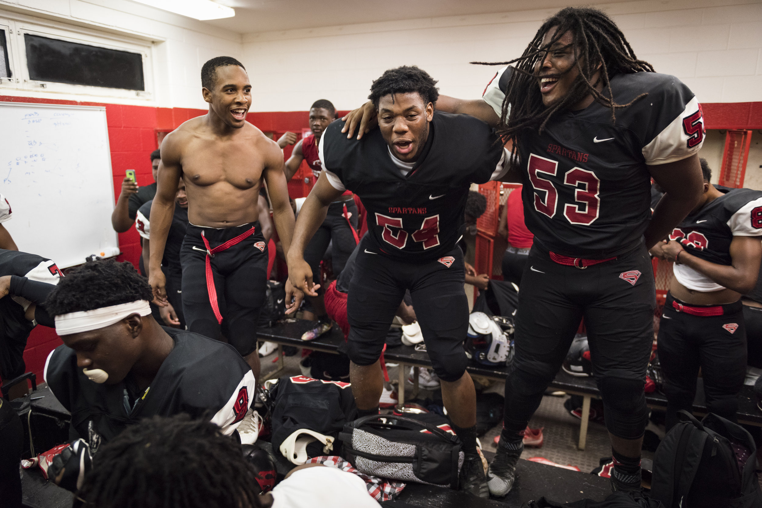  From left, Southern Durham players Curtis Justice, Deshawn Harris, and Zyon Johnson, celebrate an upset win against the No. 4 team in the region, Seventy-First High School. 