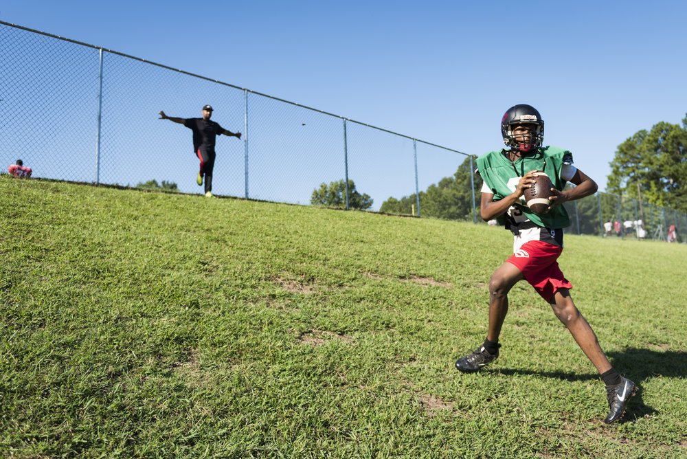  Southern Durham sophomore quarterback Omari Smith works on his footwork by running up a hill during practice. 