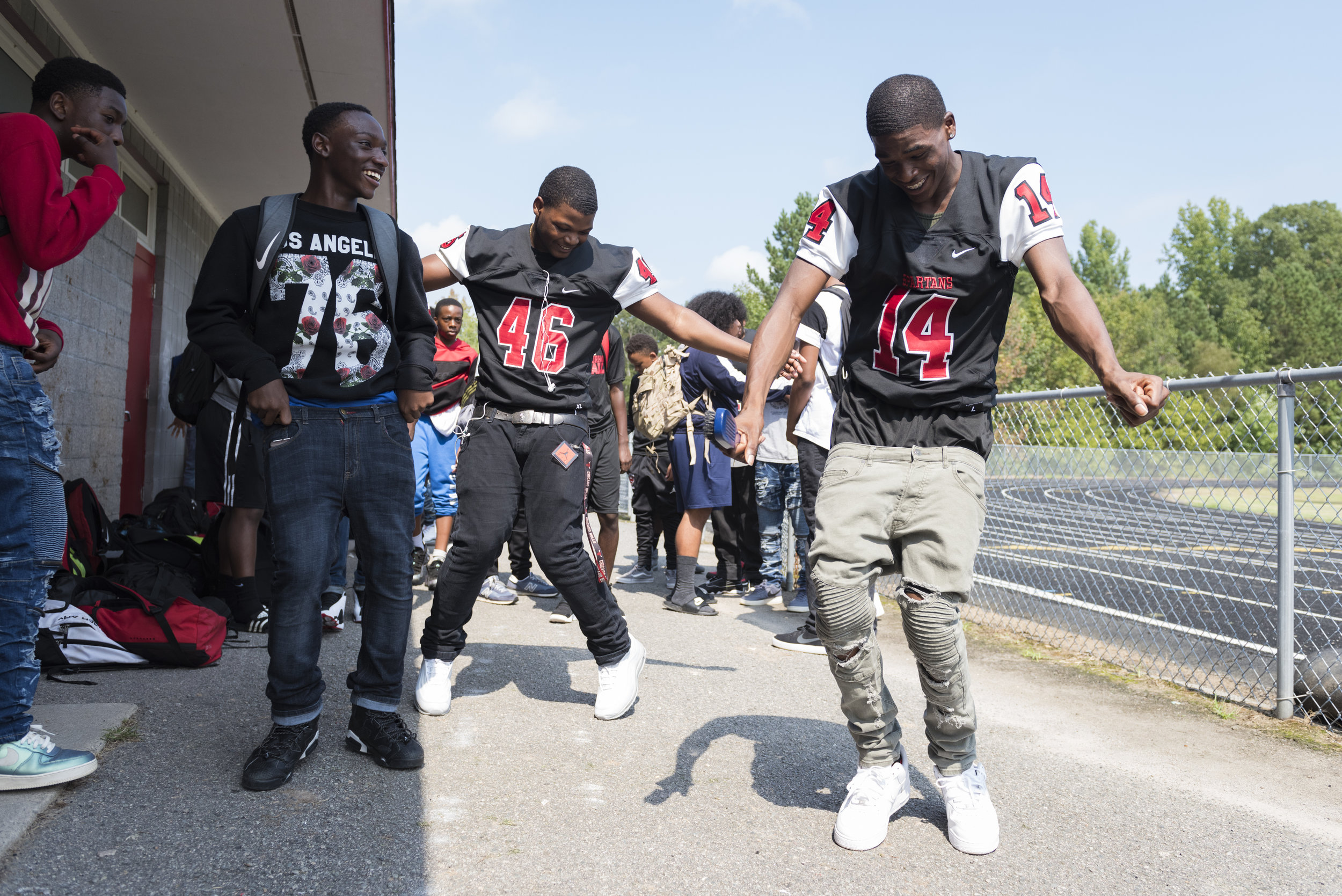  Southern Durham players Lavar Houze (46) and Cinsere Clark (14) dance during the team's homecoming pep-rally at school. 