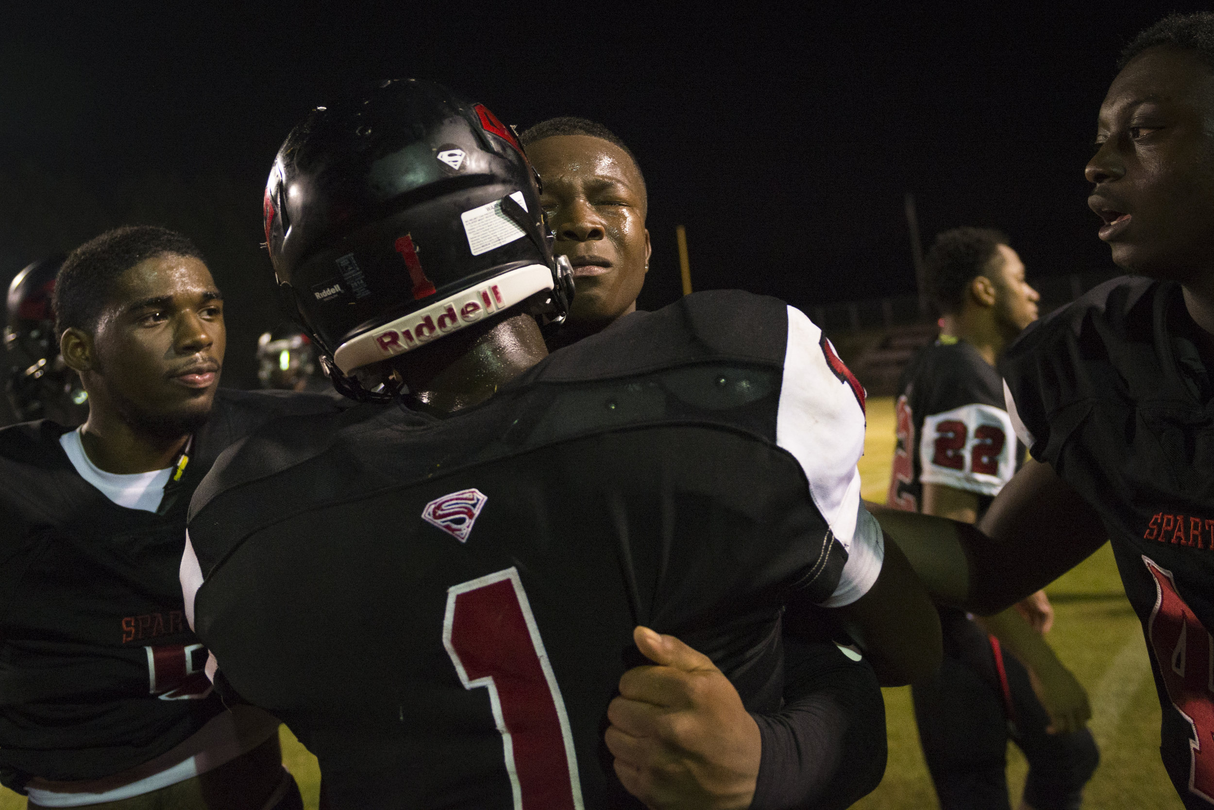  Southern Durham senior wide receiver Jaylen Lloyd is consoled by senior running back Taron Beauford (1) and teammates after a tough loss. 