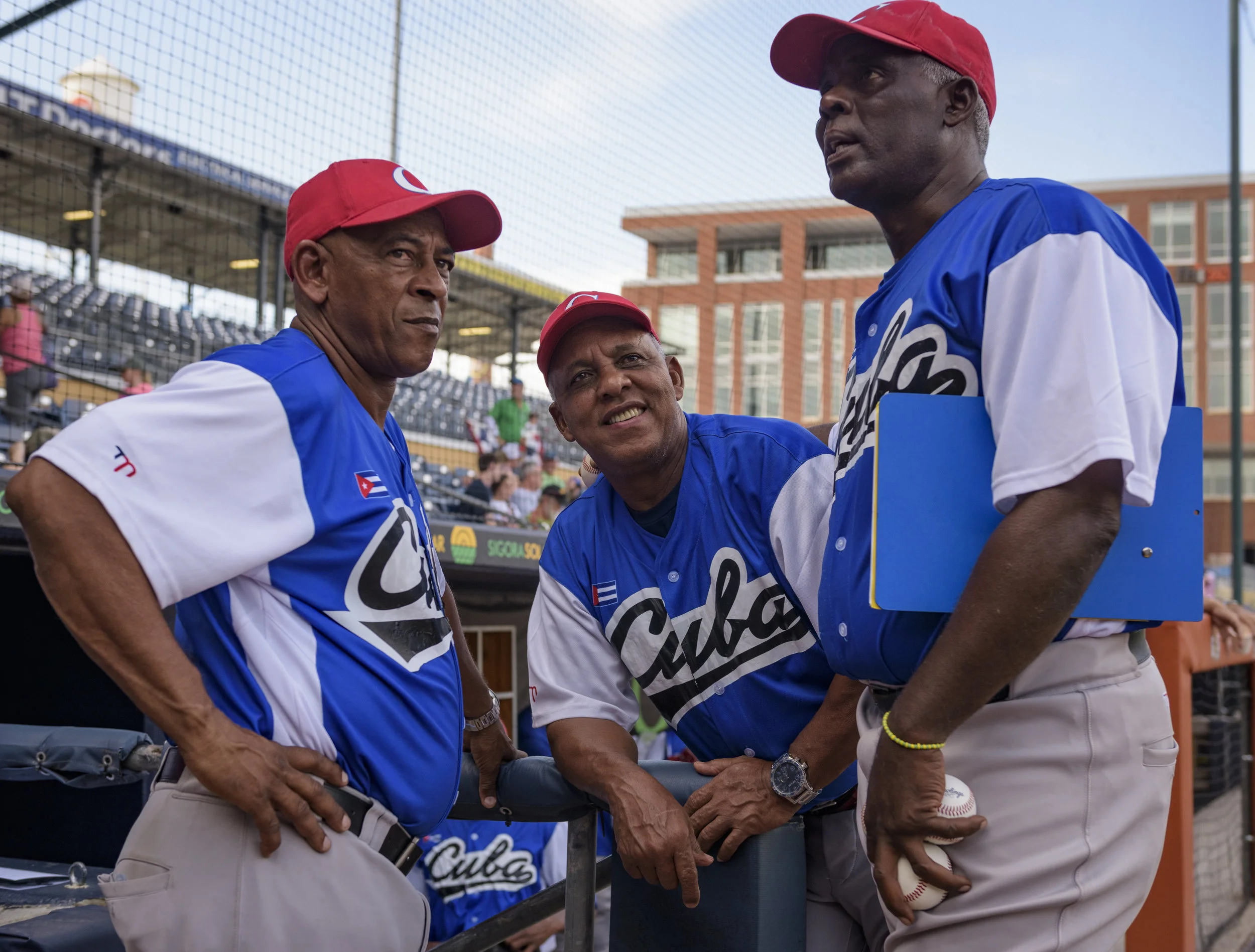 Cuba national team manager Rey Anglada (center) talks with coaches Miguel Rojas Rodriguez (left) and Javier Galvez Cordova (right) before Cuba’s game against the USA Baseball Collegiate National Team on July 6, 2019 at Durham Bulls Athletic Park in Durham, NC.