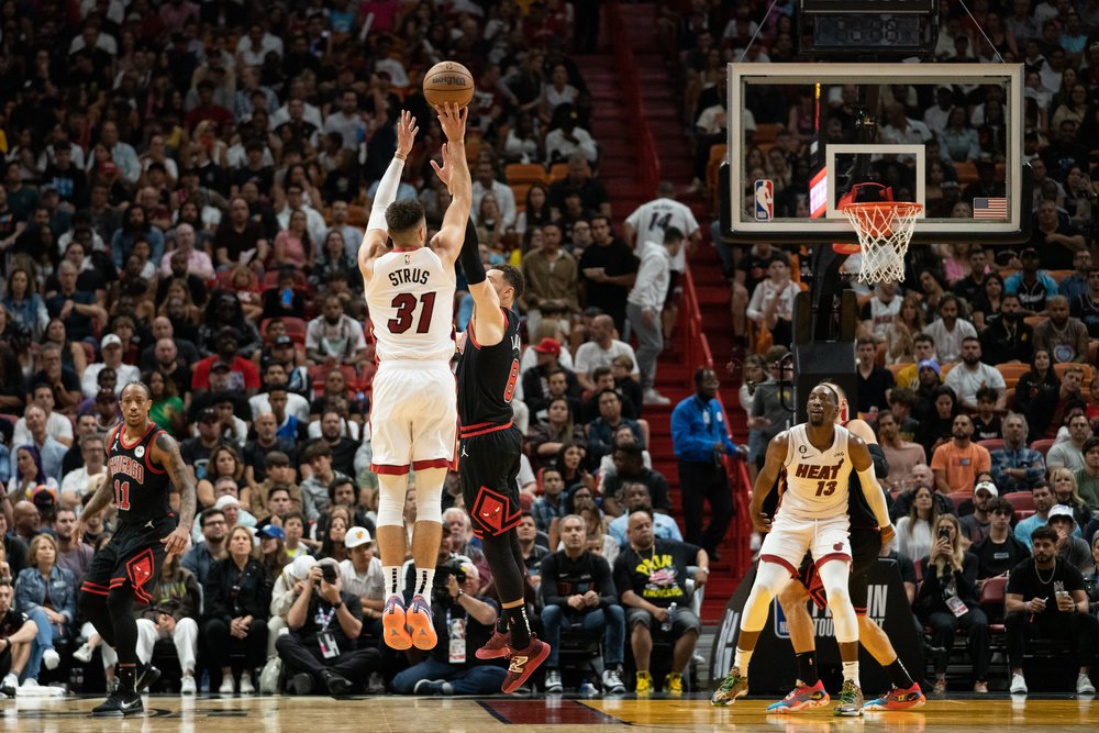  MIAMI, FL - APRIL 14: Max Strus #31 of the Miami Heat shoots a three pointer while being defended by Zach LaVine #8 of the Chicago Bulls at Kaseya Center on April 14, 2023 in Miami, Florida. 