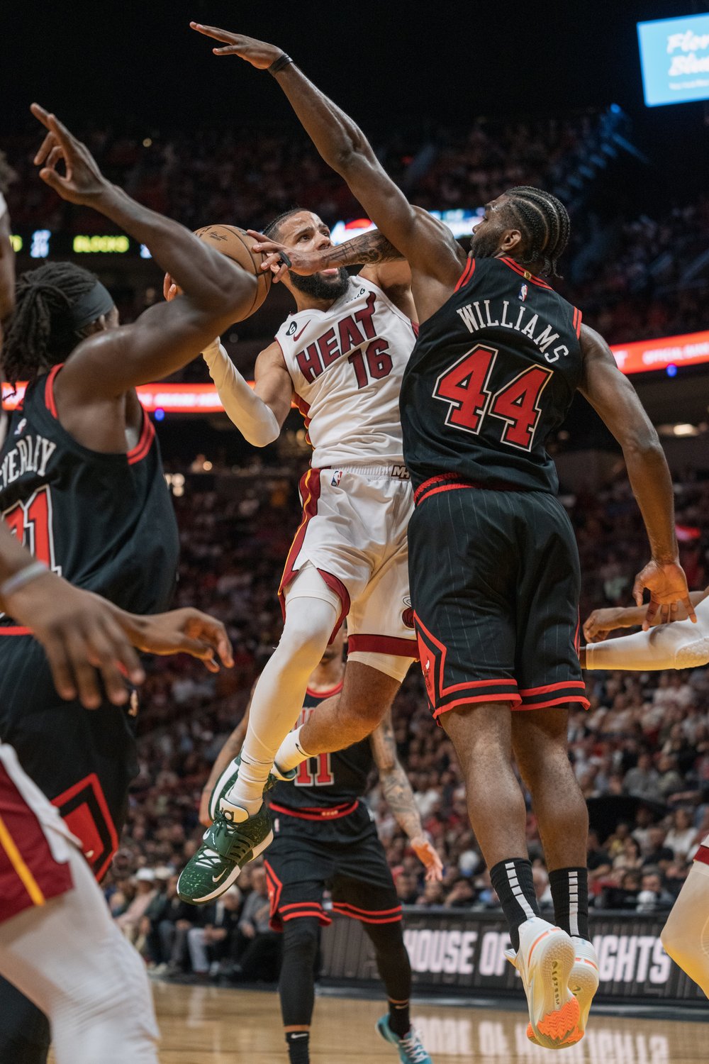  MIAMI, FL - APRIL 14: Caleb Martin #16 of the Miami Heat attempts to shoot the ball while being defended by Patrick Beverley #21 of the Chicago Bulls (L) and Patrick Williams #44 of the Chicago Bulls at Kaseya Center on April 14, 2023 in Miami, Flor