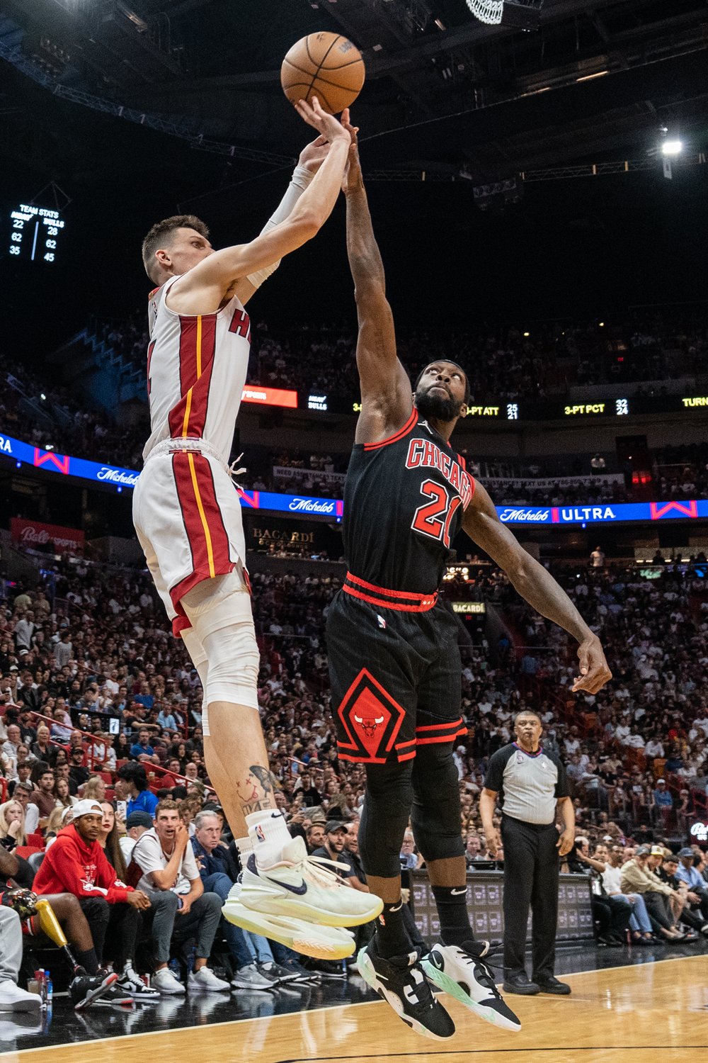 MIAMI, FL - APRIL 14: Tyler Herro #14 of the Miami Heat attempts a three point shot while being defended by Patrick Beverley #21 of the Chicago Bulls at Kaseya Center on April 14, 2023 in Miami, Florida. 