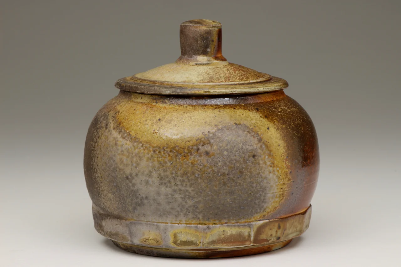 Covered jar, 8" high, stoneware with local clay slip.