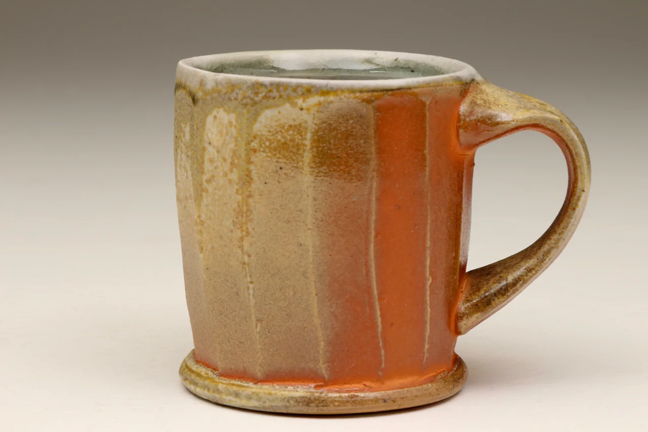 Coffee cup, 4" high, stoneware with flashing slip.