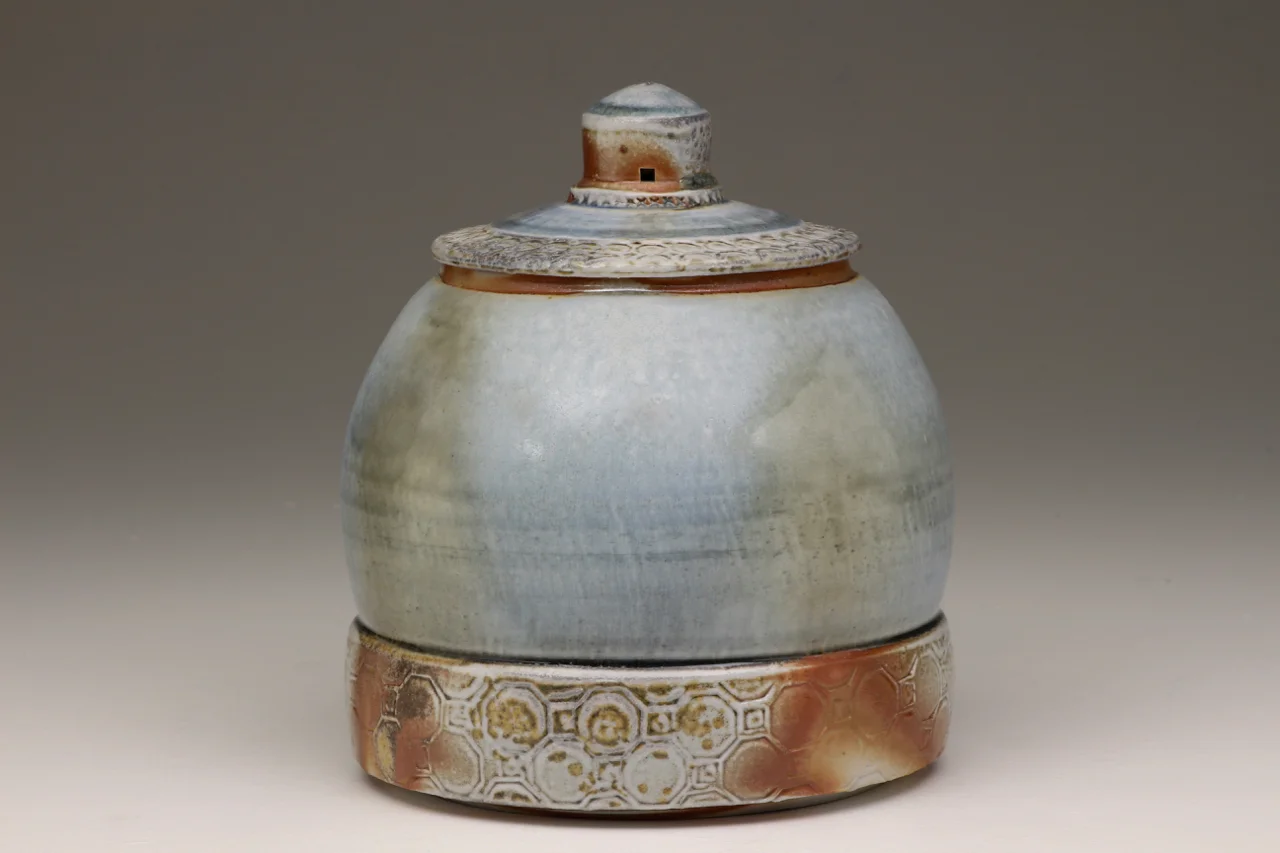 Covered Jar, 8" high, glazed porcelain with flashing slip, soda chamber.